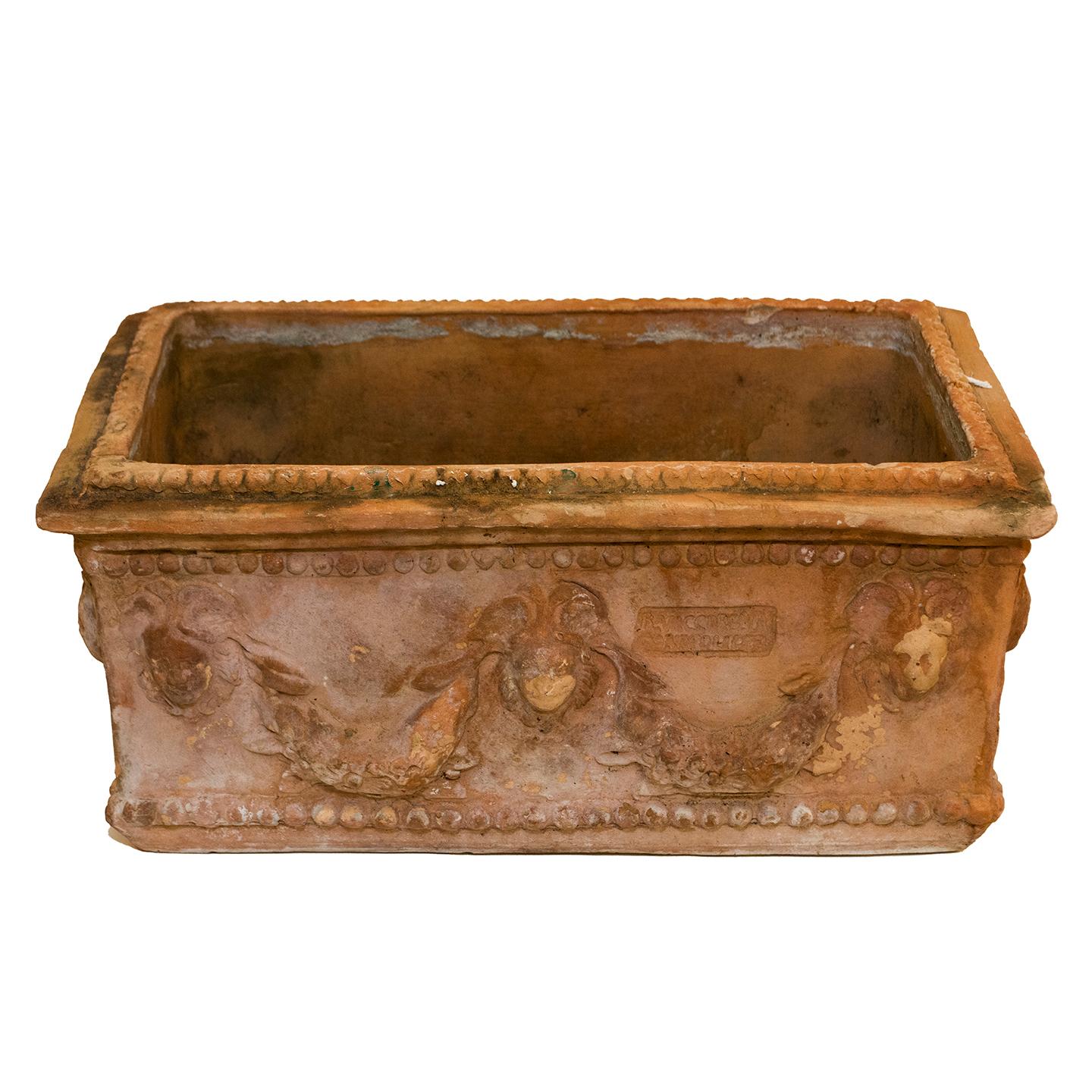 An Antique Neapolitan terra cotta planter adorned with festoons and lion heads. This attractive planter would make a stunning addition to your garden, window box, out on your deck, or in a sunny spot inside your home. They are stamped R Vaccarella,