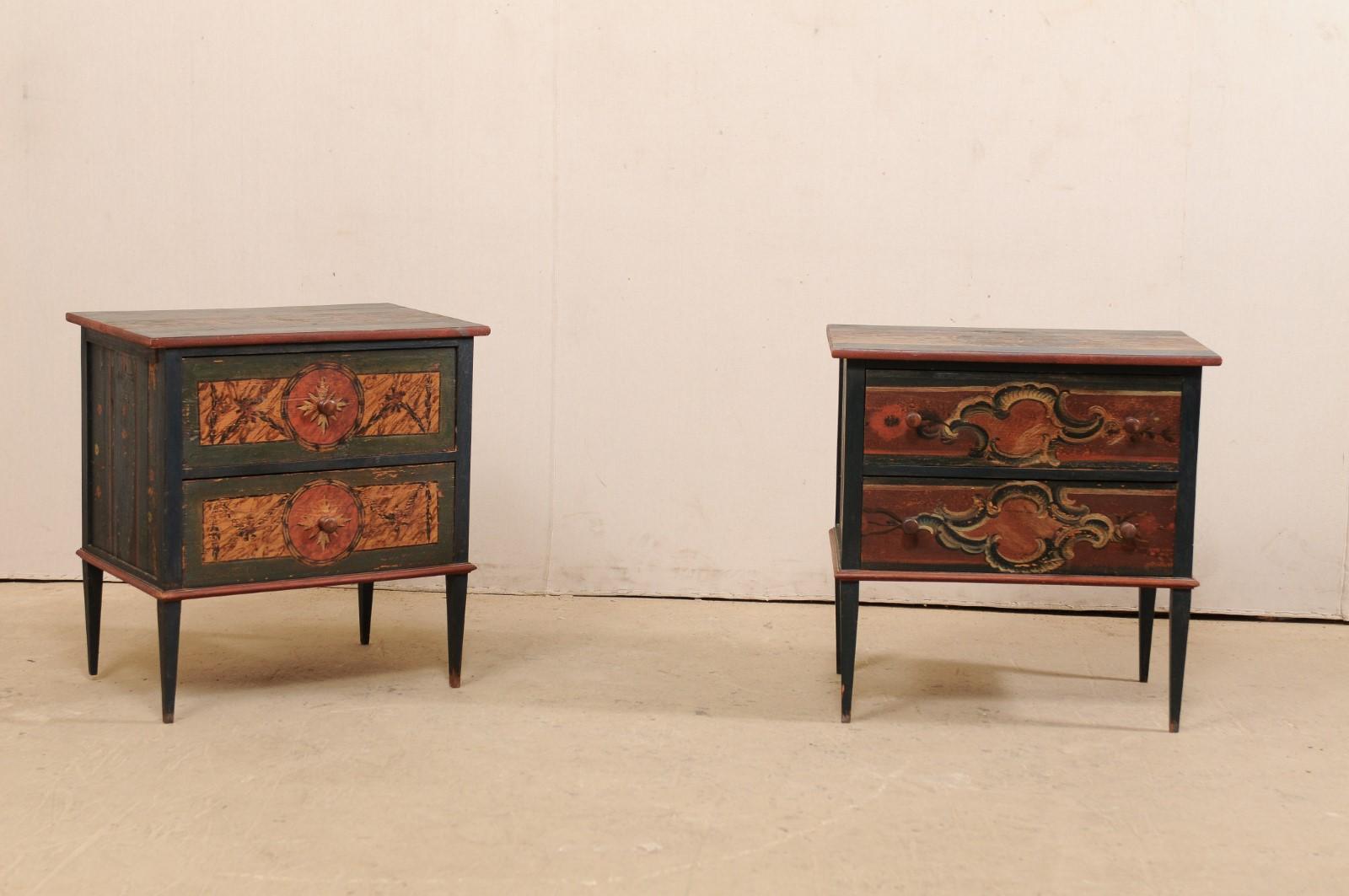This is a delightful near-pair of Hungarian chests with their original artistic hand-paint finish from the early 20th century. This antique pair of commodes from Hungary, each featuring two dove-tailed drawers and nicely presented upon tapered