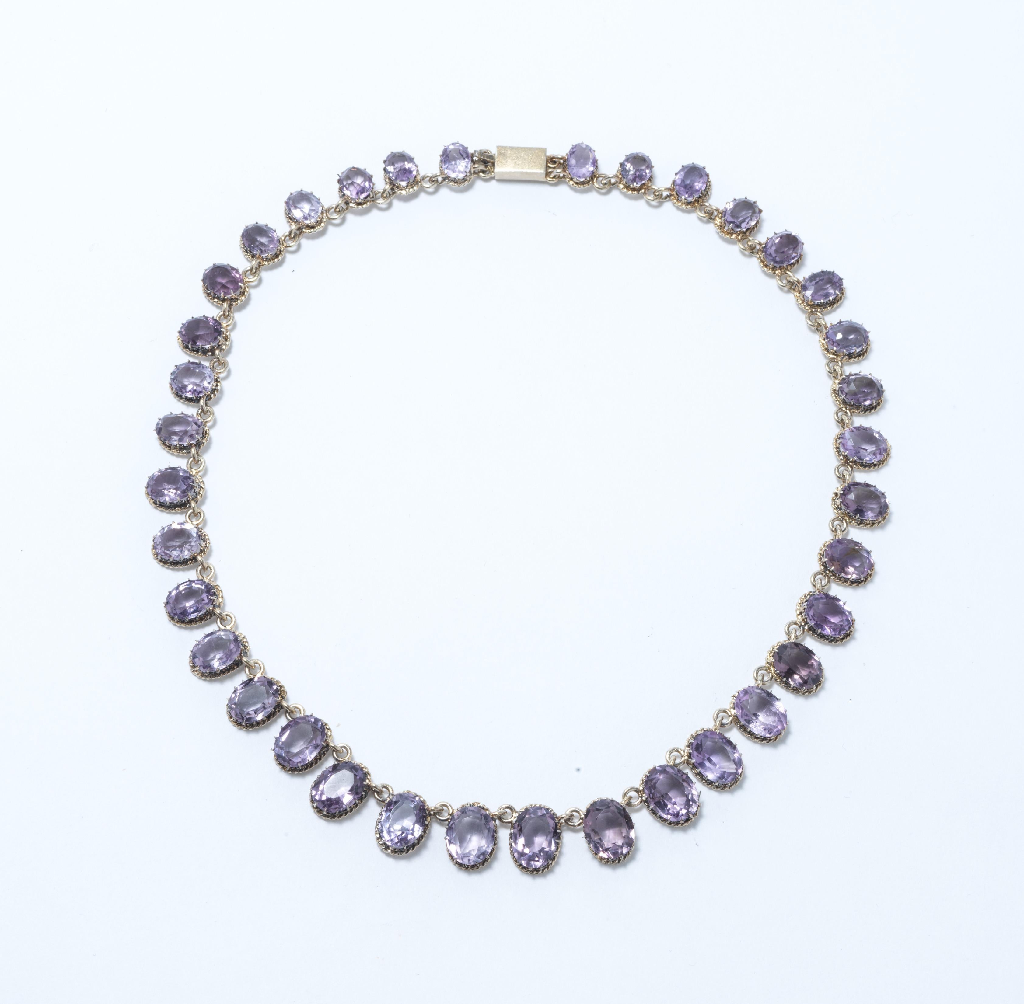 A beautiful antique necklace made in the second half of the 19th c. It is made of gilt silver and has 36 amethysts going from smaller to larger and then smaller again. The design of the necklace is simple but just so elegant. This is a piece that