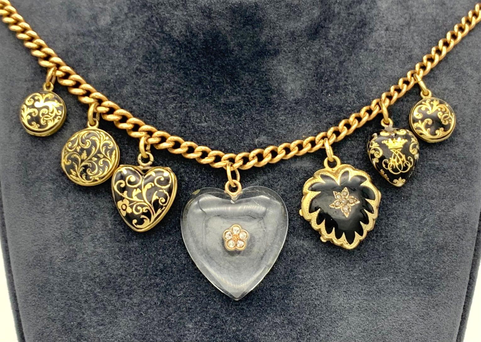 Wonderful necklace made out of four hearts, three of them are lockets anf the largest heart in the center is a wonderful heart shaped rock crystal cabochon. The other pendants are three round enamelled lockets. All the pendants are suspended from a