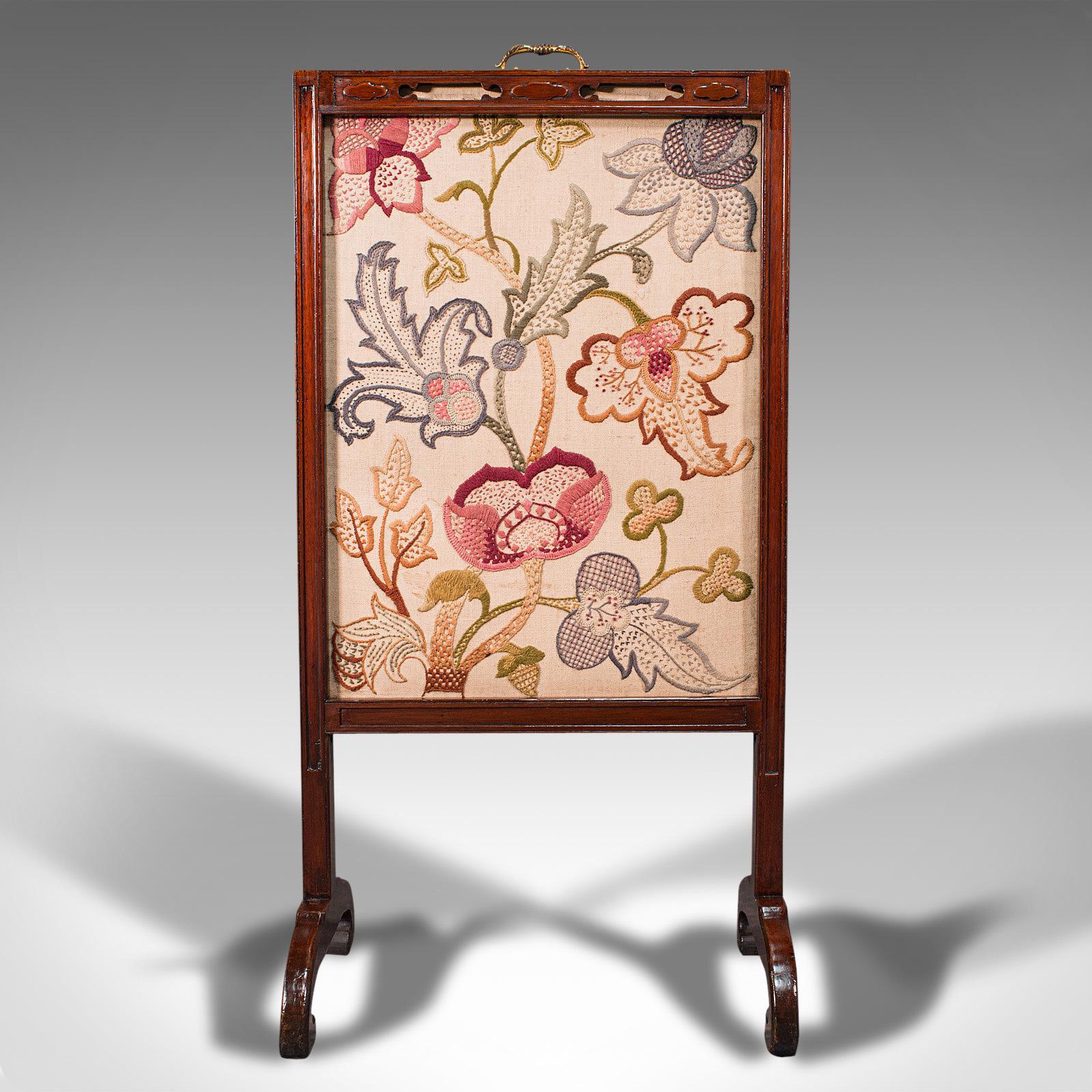 This is an antique needlepoint fire screen. An English, mahogany fireside guard with tapestry screen, dating to the Regency period, circa 1830.

Attractive fire screen with Chinese Chippendale overtones
Displaying a desirable aged patina and in