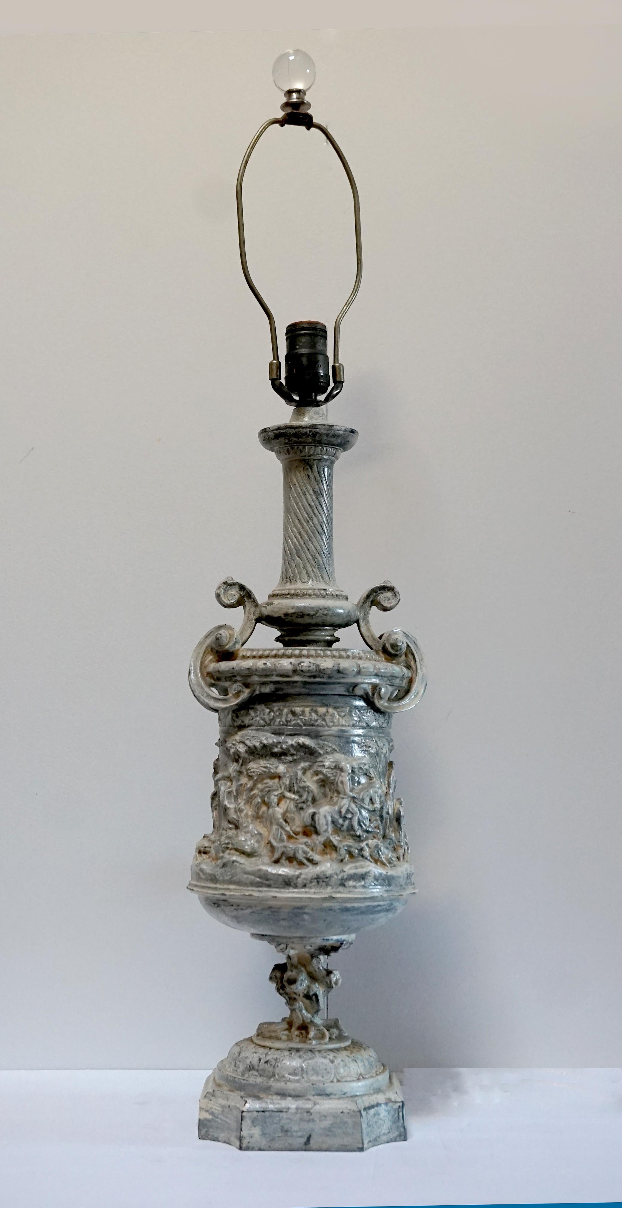 The white enamel wash, the scene reminiscent of a classical Greek or Roman setting, and the urn form make this French Zinc lamp unique and irresistible. The antique Neoclassical style cast metal footed urn lamp body probably 19th Century; probably