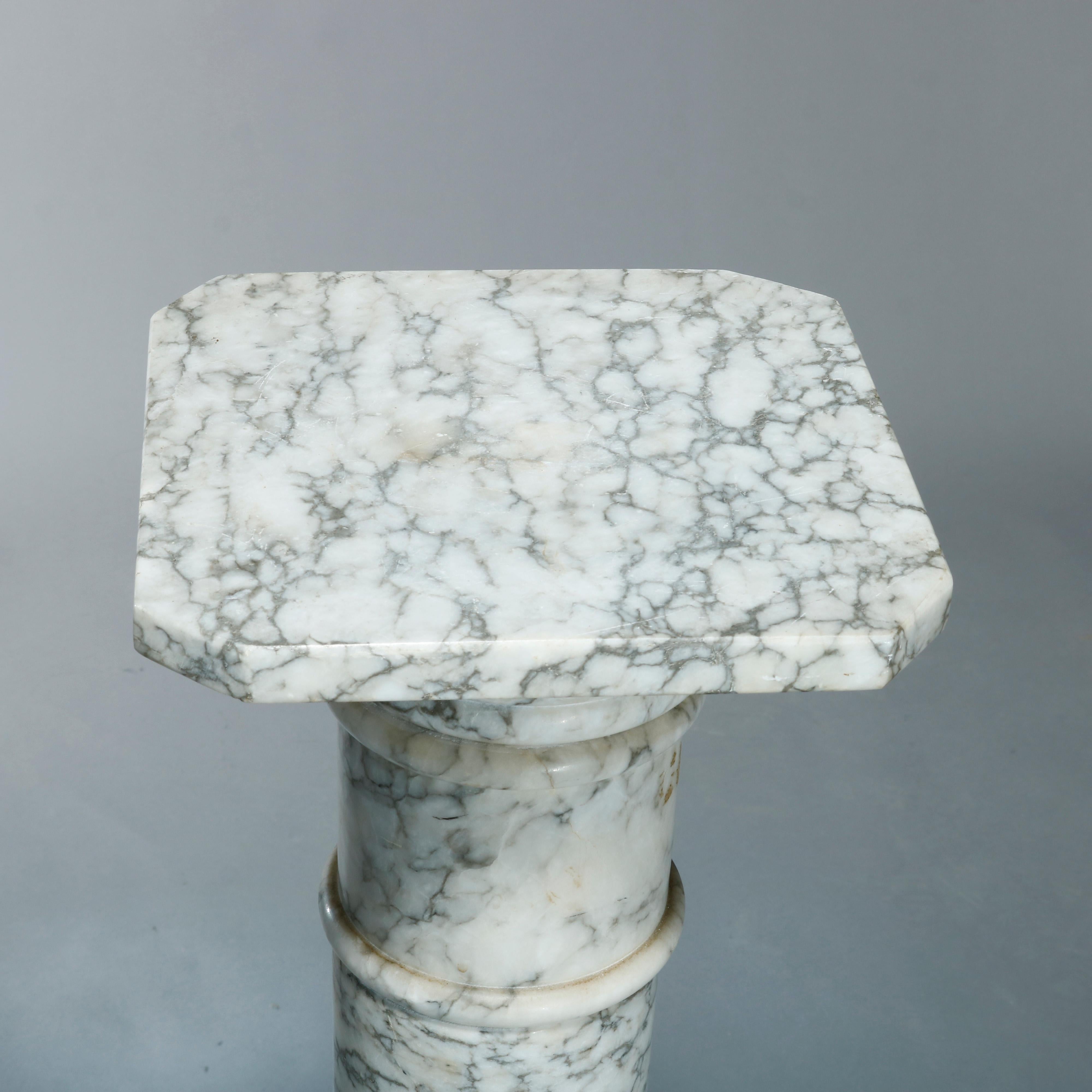 An antique neo-classical carved variegated marble display sculpture pedestal offers Doric column-form with clipped corner display and octagonal and stepped base, circa 1900.

Measures: 39.5