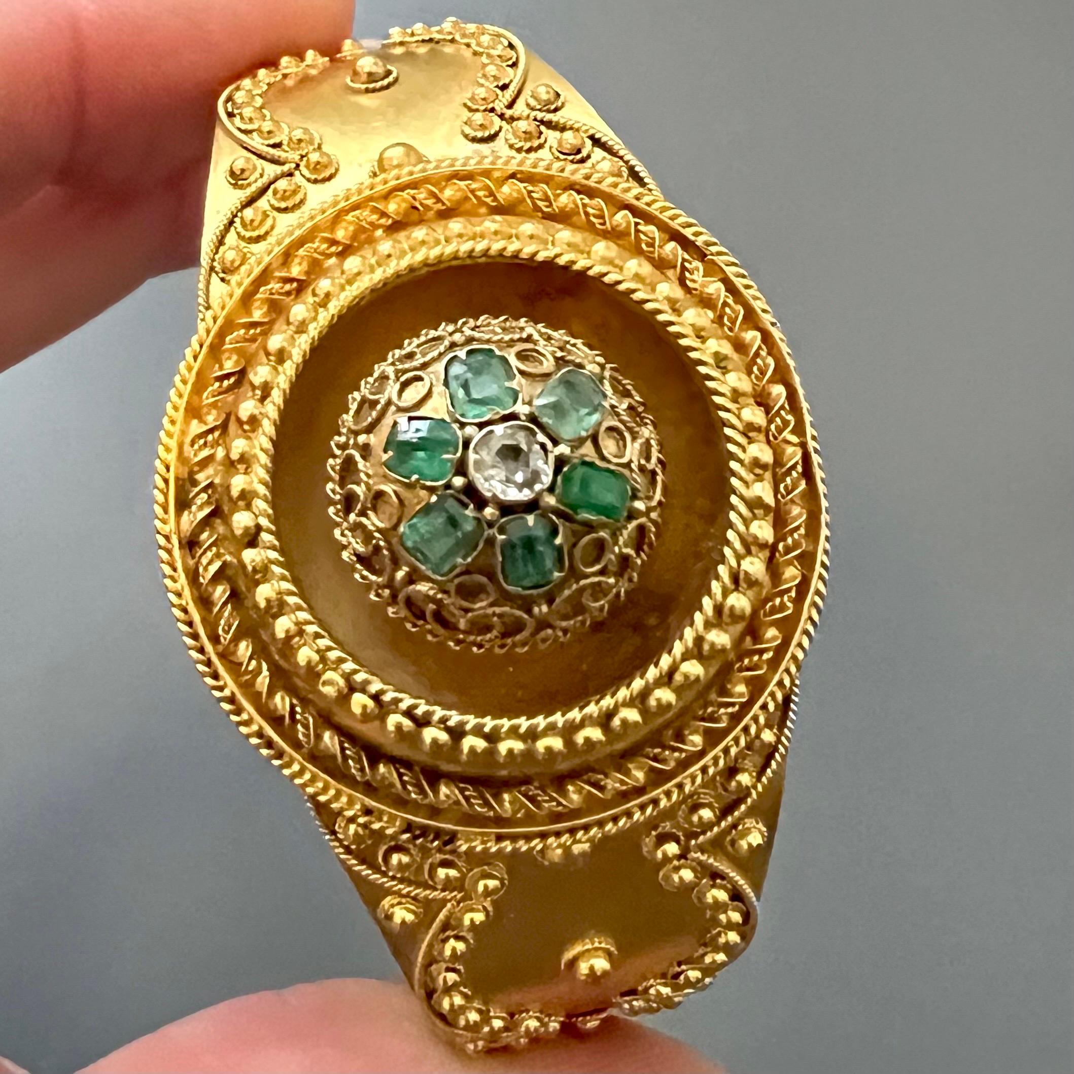 This magnificent 19th-century bracelet, crafted in England, is an outstanding example of Neo-Etruscan jewelry design, blending timeless elegance with intricate craftsmanship. Made from 18 karat gold, it features a central appliqué adorned with a