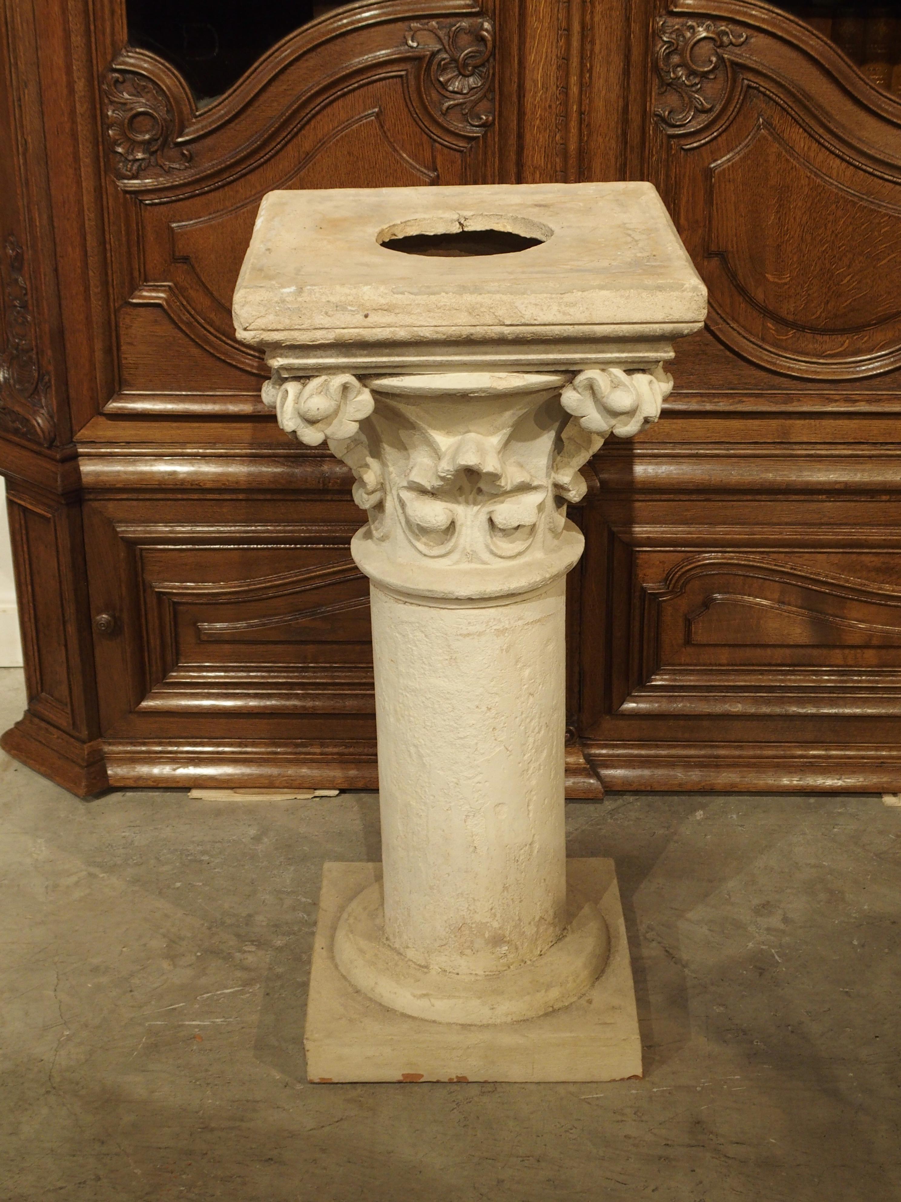 This painted terra cotta columnar pedestal is composed of a base, column, floral capital, and a stepped in square top. The style of the capital is typical Neo-Gothic which was popular in France between the mid 1800s and early 20th century. The paint