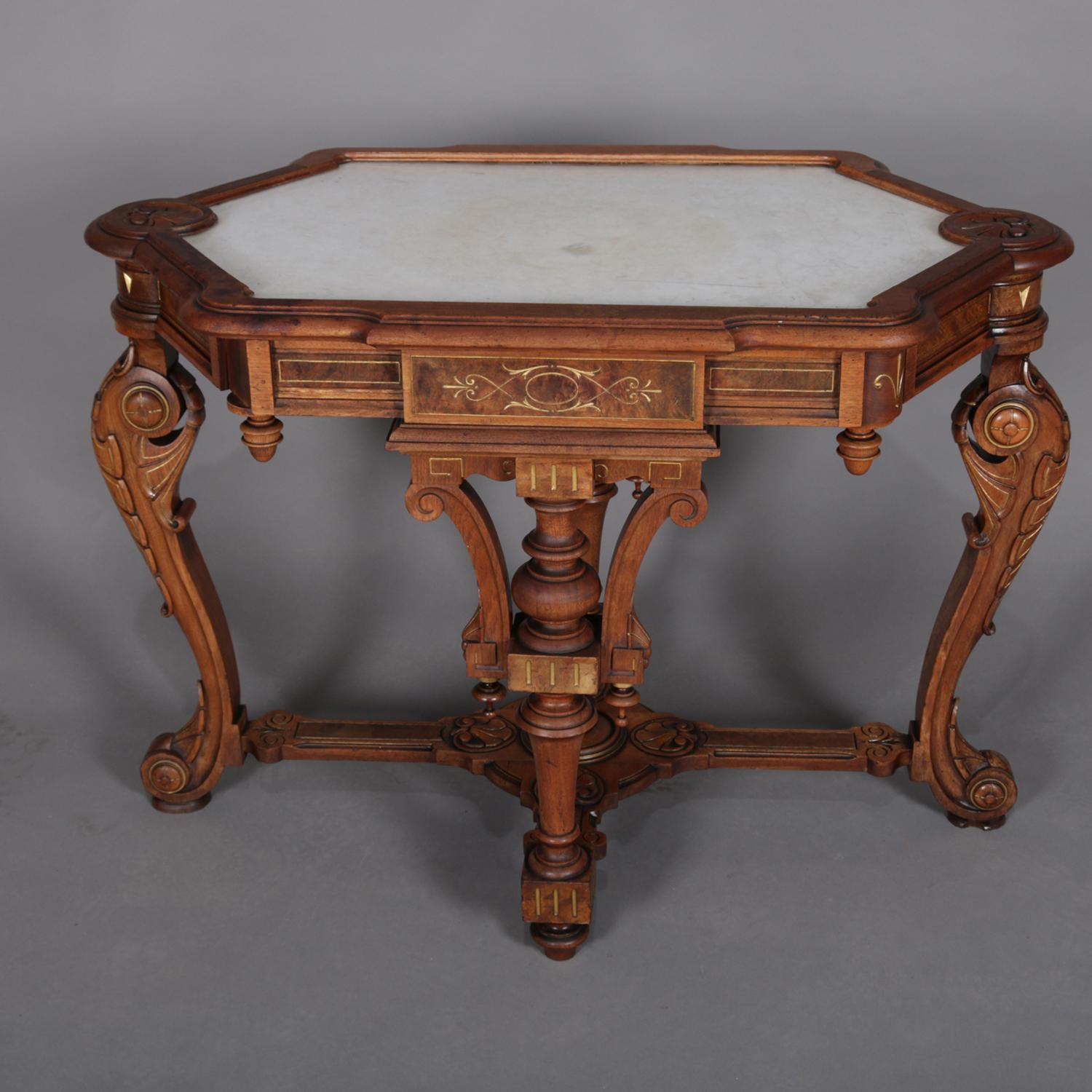 An antique neo Greco walnut center table features neoclassical design with elongated hexagonal form having inset picture frame marble top with gilt and burl decorated skirt accented with drop finials and raised on carved acanthus form legs, circa