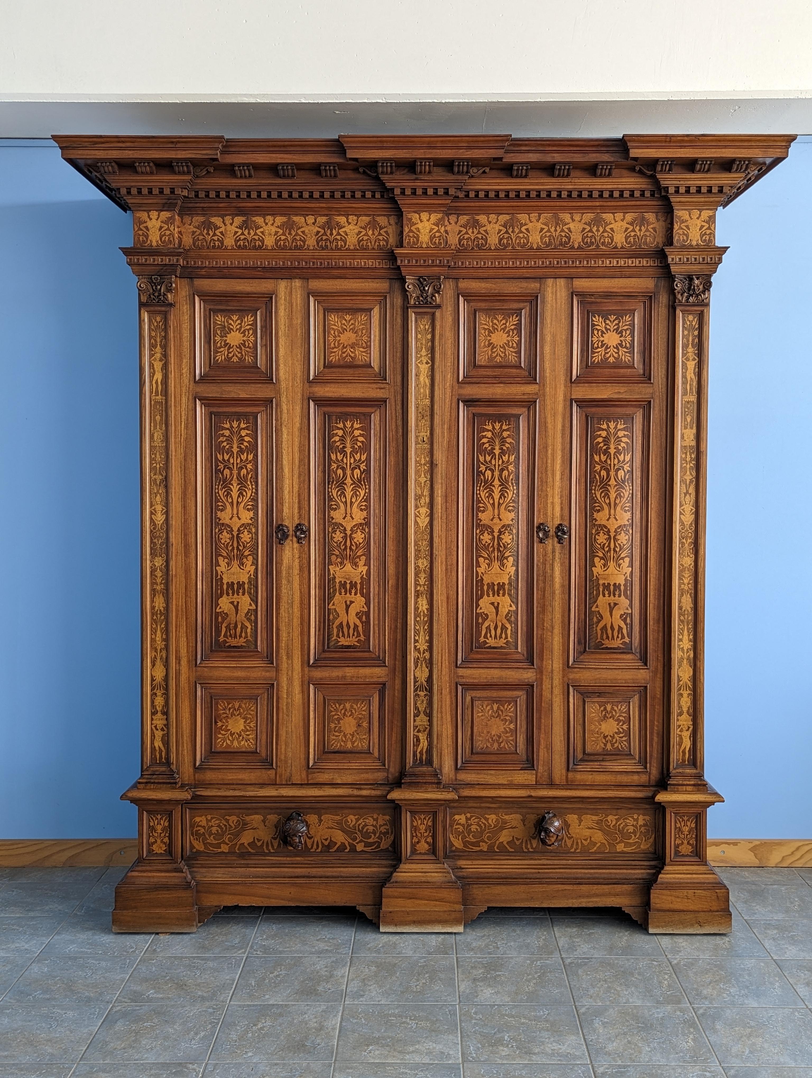 This stunning antique armoire is a true masterpiece of neo-Renaissance design, crafted in the late 19th century in Continental Europe, most likely in Austria or Germany. Its rich walnut exterior is complemented by a spruce interior, providing a