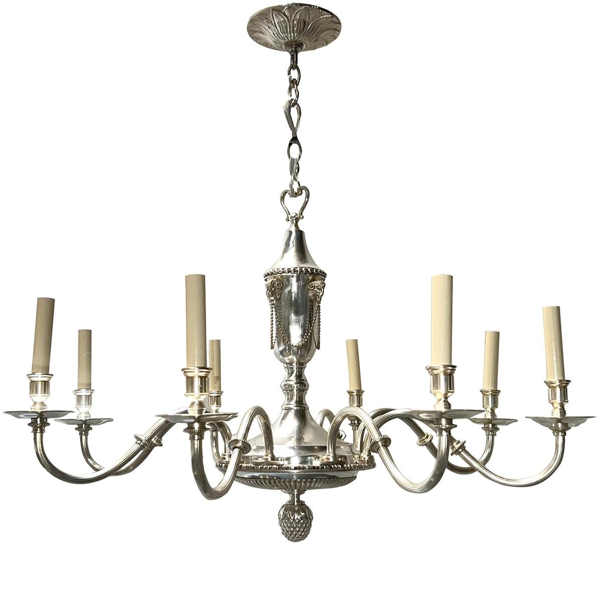 A circa 1920 English silver plated chandelier with original finish, with 8 lights.

Measurements:
Diameter: 34