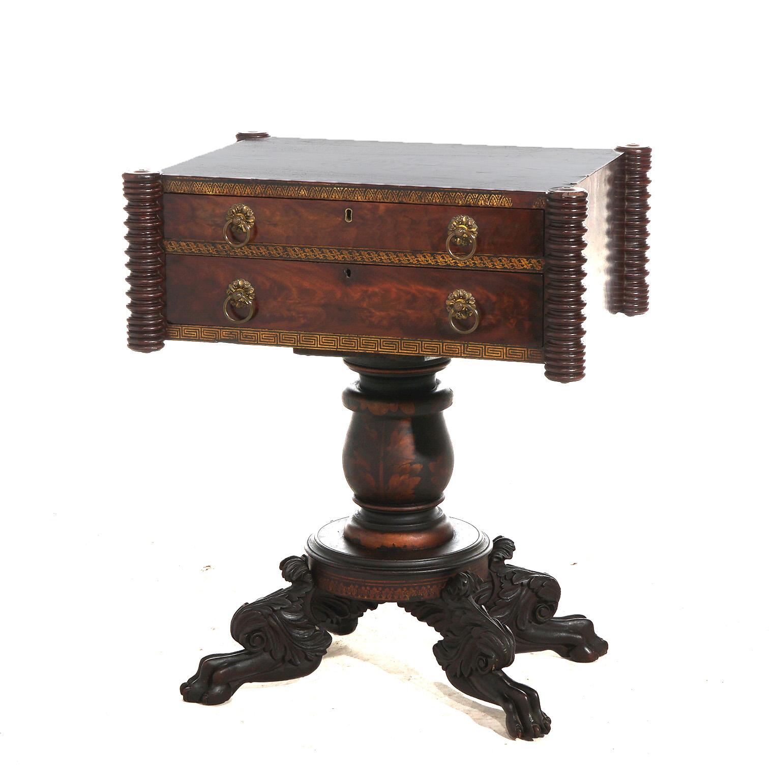 ***Ask About Reduced In-House Delivery Rates - Reliable Professional Service & Fully Insured***
Antique Neoclassical inspired work table offers flame mahogany construction with case have two drawers, flanking spool columns and gilt stenciled