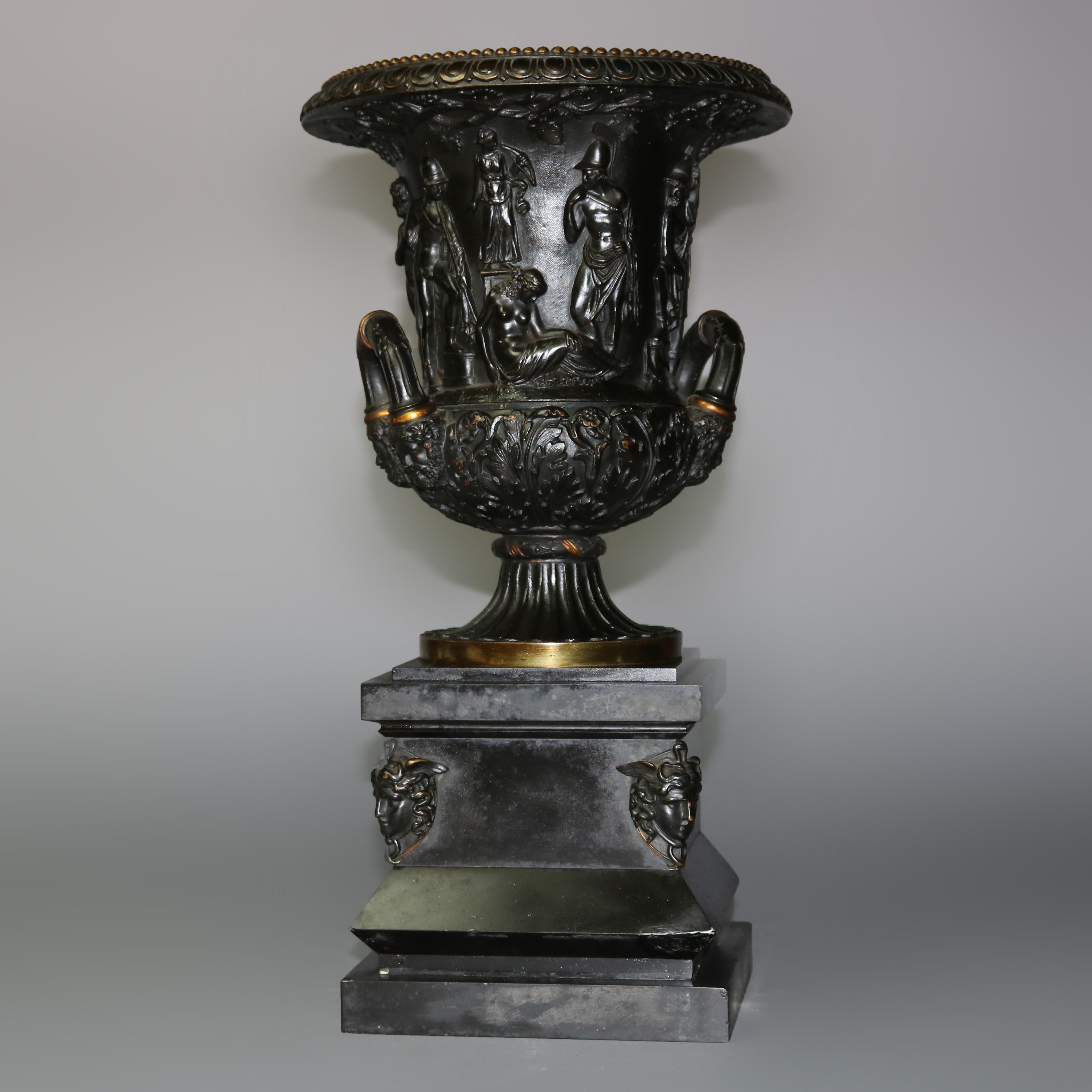 An antique pair of French neoclassical urns in the manner of Barbedienne offer crisply cast and parcel gilt bronze construction with high relief figures and foliate decoration, double handles, raised on a fluted plinth and seated on stepped base