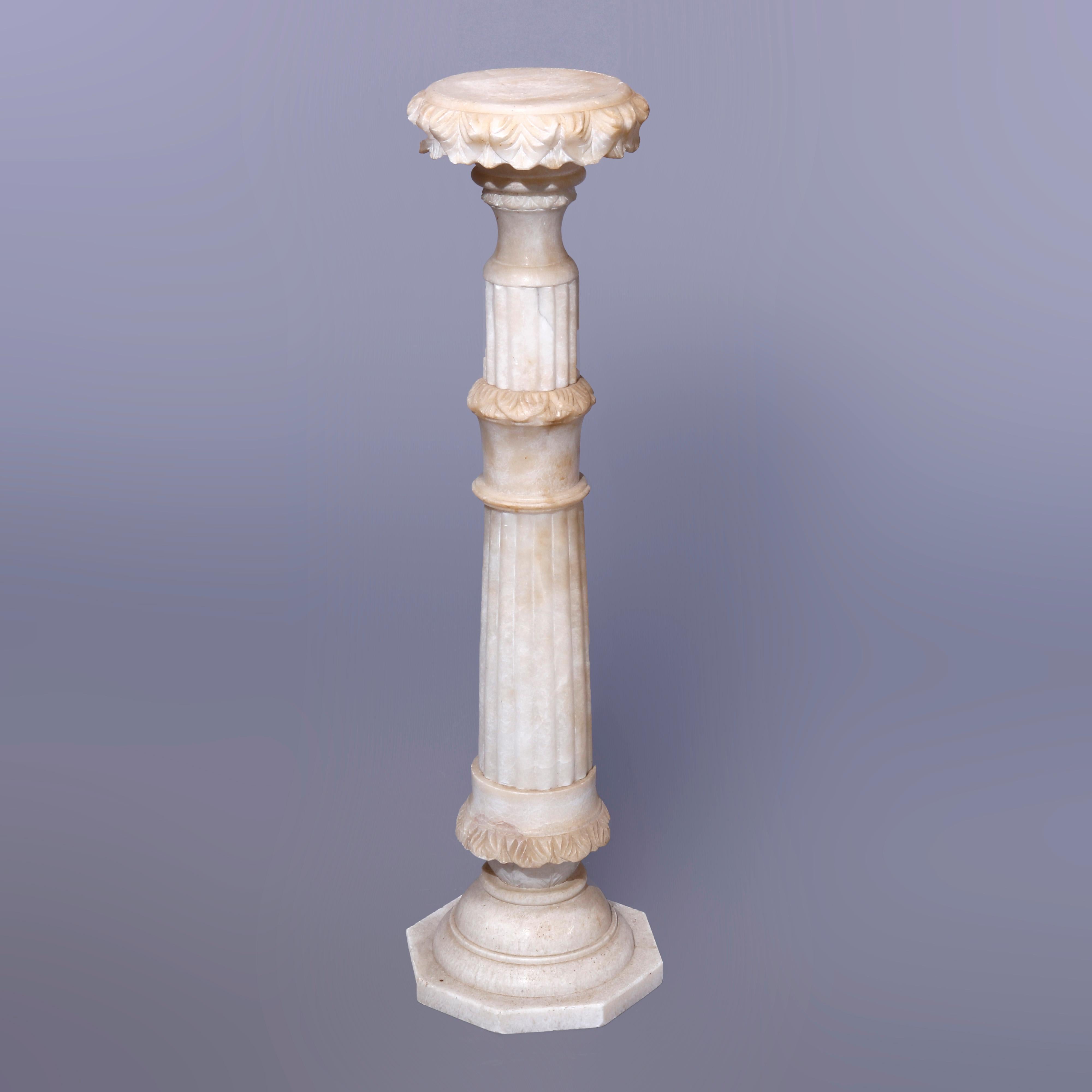 An antique Neoclassical sculpture pedestal offers carved alabaster construction with round display having carved acanthus bordering over flared and reeded column with carved foliate banding, raised on stepped base, c1890

Measures - 40.25''H x 11''W