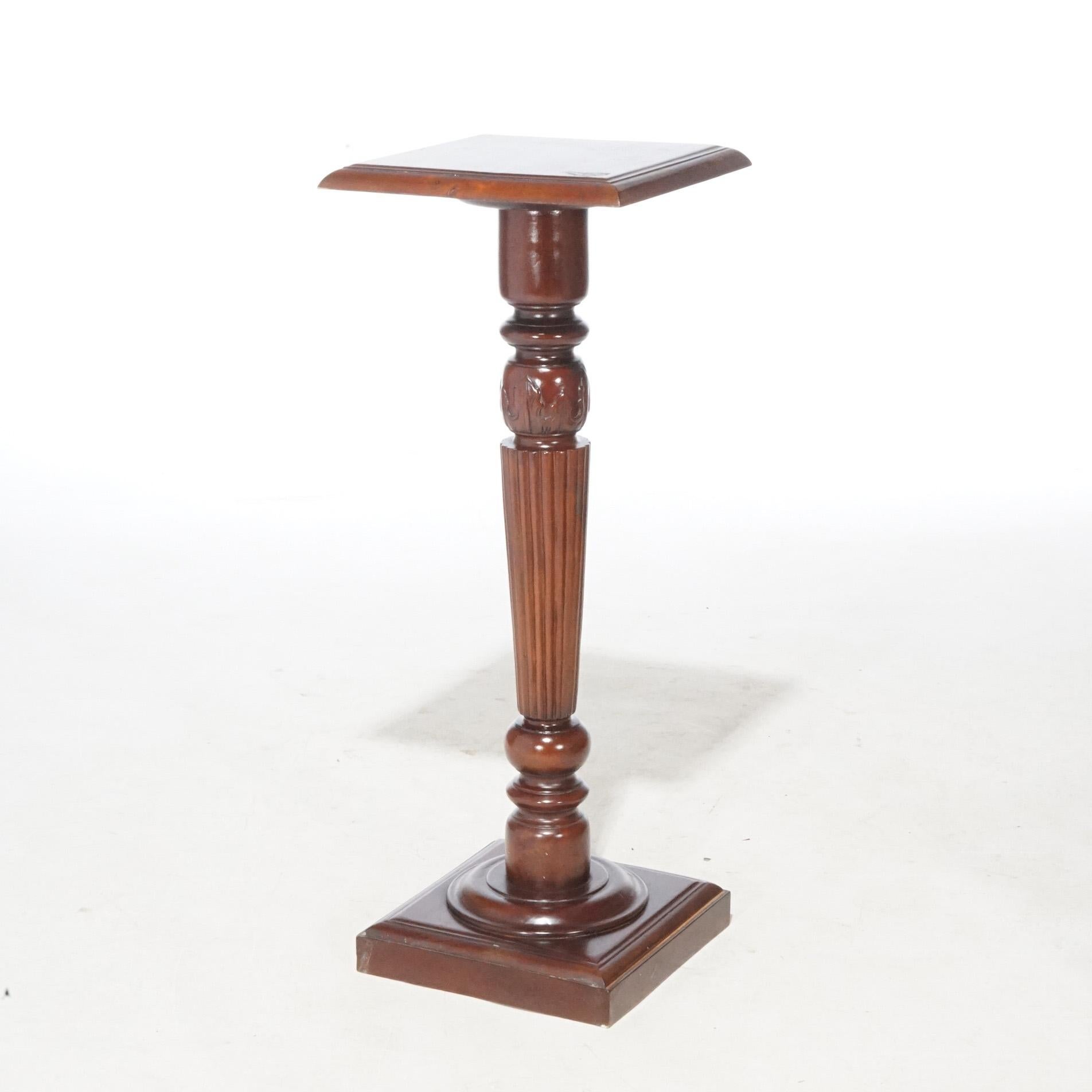 An antique Neoclassical sculpture pedestal offers mahogany construction with square display raised on turned, tapered and reeded column, circa 1900

Measures - 39.5