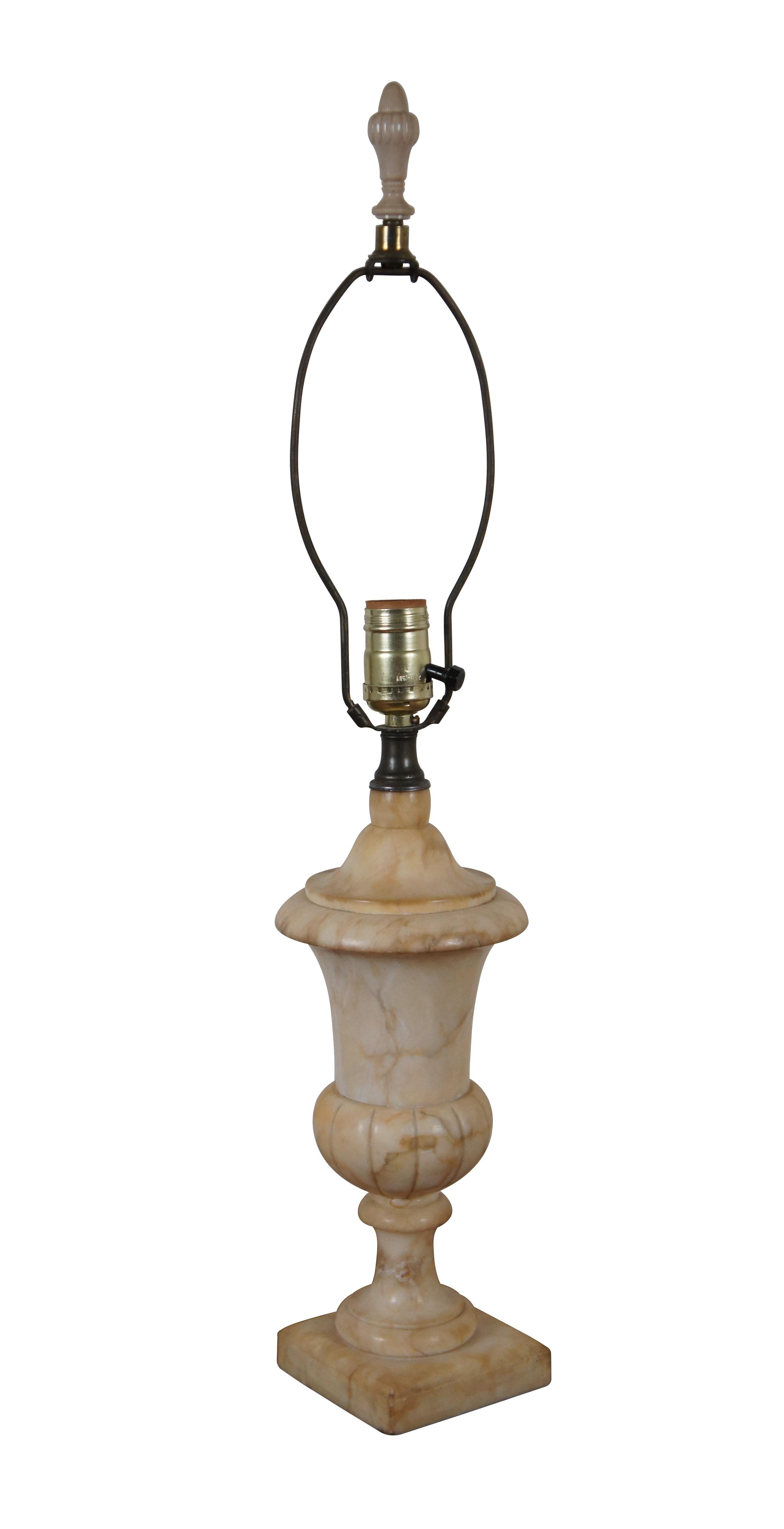 Antique beige and cream marble / alabaster / stone table lamp, carved in the shape of a Neoclassical vase. Includes harp, pleated fabric shade, and cream colored Bakelite finial.

Dimensions:
5.25