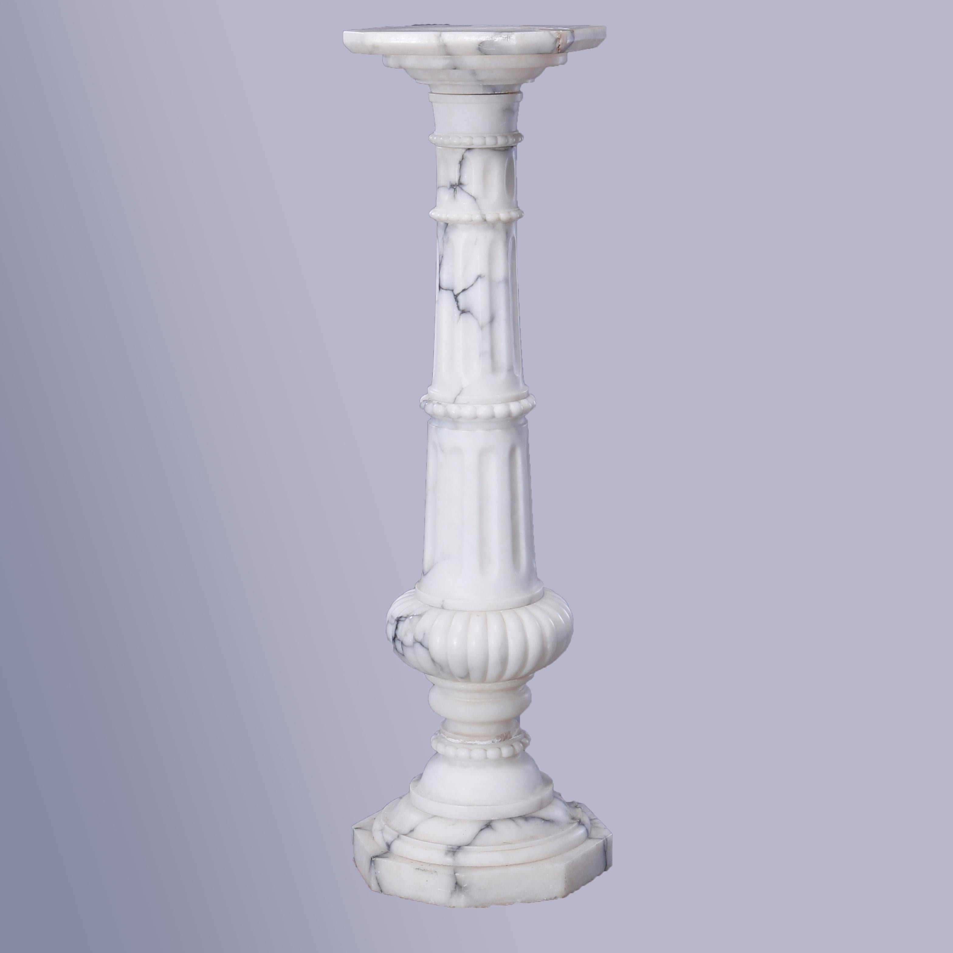 An antique Neoclassical sculpture pedestal offers carved marble construction with clipped corner display over flared column with beaded banding with lower melon raised on stepped base with octagonal foot, c1890.

Measures - 45.5''H x 13''W x