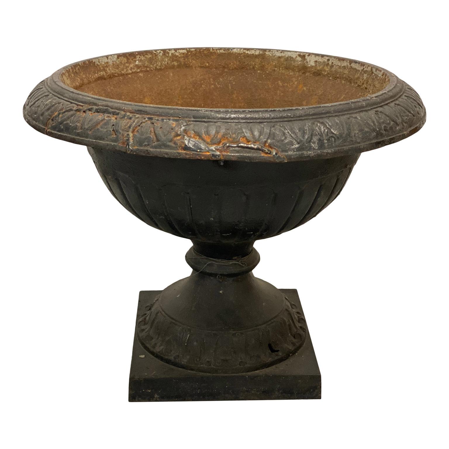 Neoclassical iron urn, aged patina.

20 H x 26.5 Top OAD x 12 Square base.