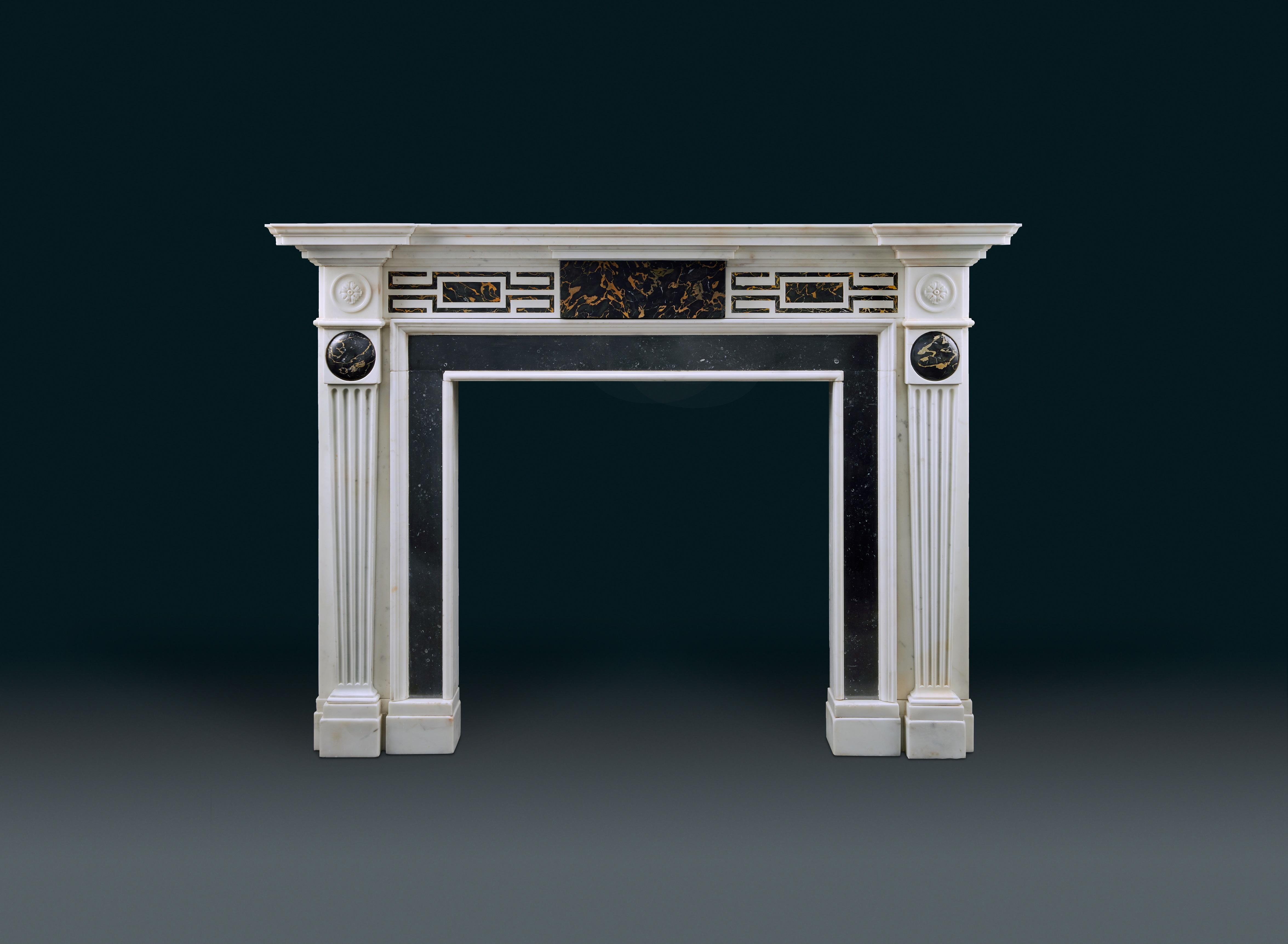 A late 18th century, neoclassical English statuary marble chimneypiece, inlaid with contrasting Portoro Nero marble, circa 1795
With moulded shelf breaking forward and protruding over the jambs. The frieze is centred with a tablet of choice specimen