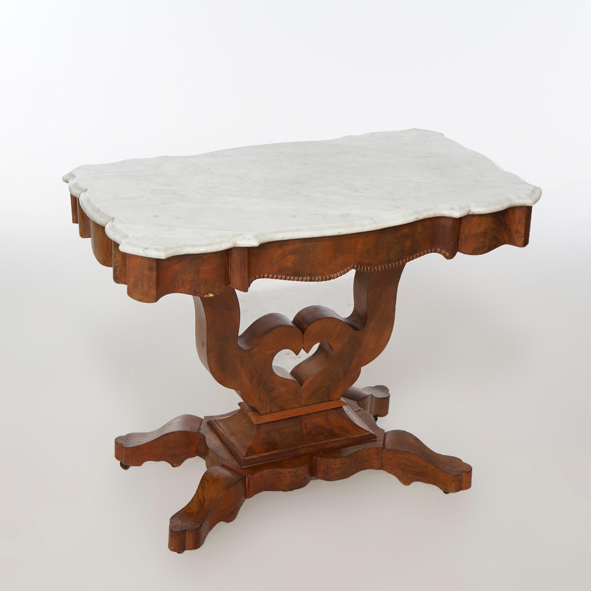 An antique American Empire parlor table offers beveled and shaped turtle top over flame mahogany lyre-form scroll base, raised on stylized cabriole legs, c1880

Measures- 29.5''H x 37''W x 21''D