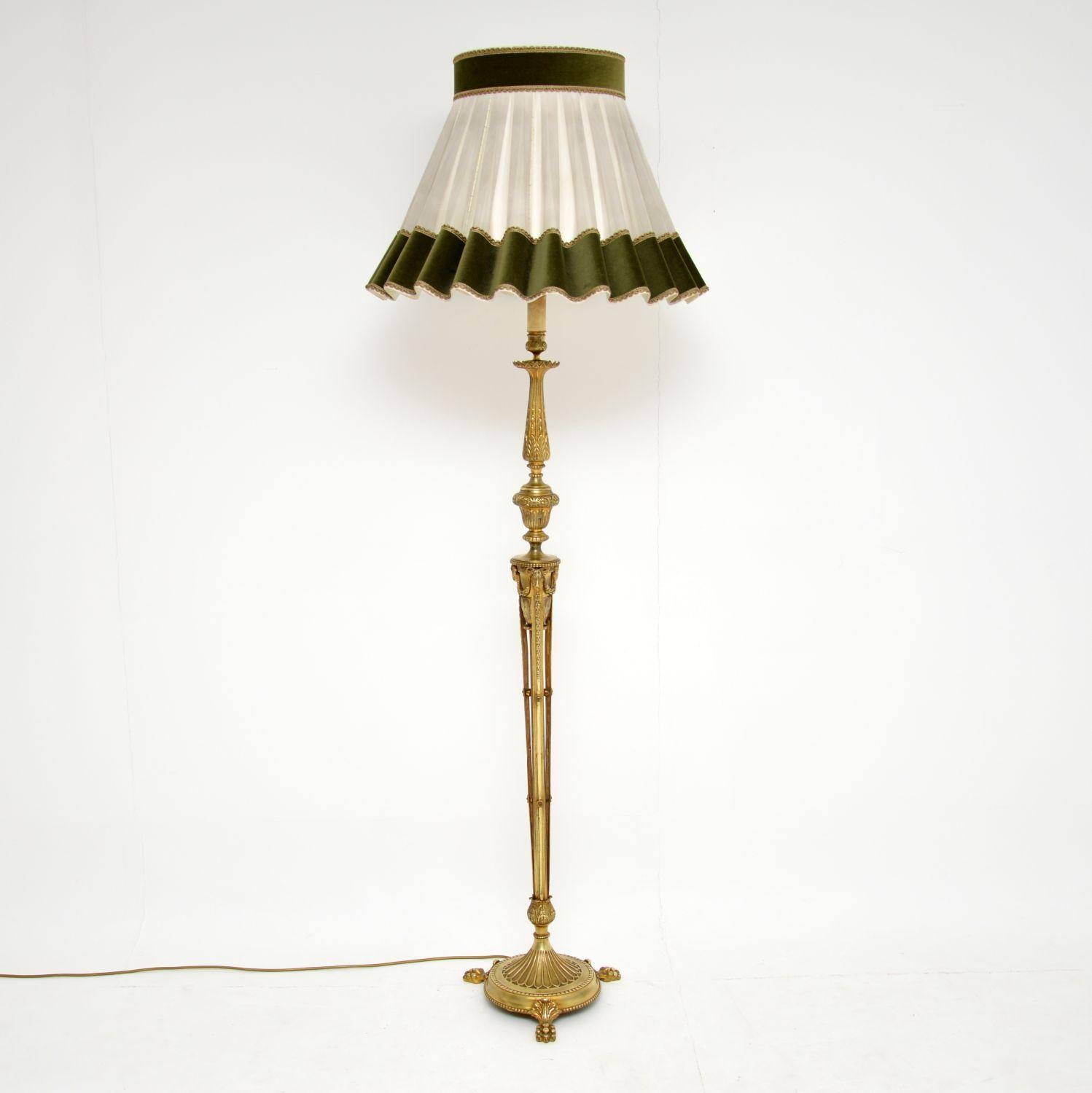 Antique French gilt brass floor lamp with many classical castings & applied decorations.

This lamp stand has been cleaned up & re-wired, so is in working condition & we have the lovely shade that came with it, which I think compliments it nicely.