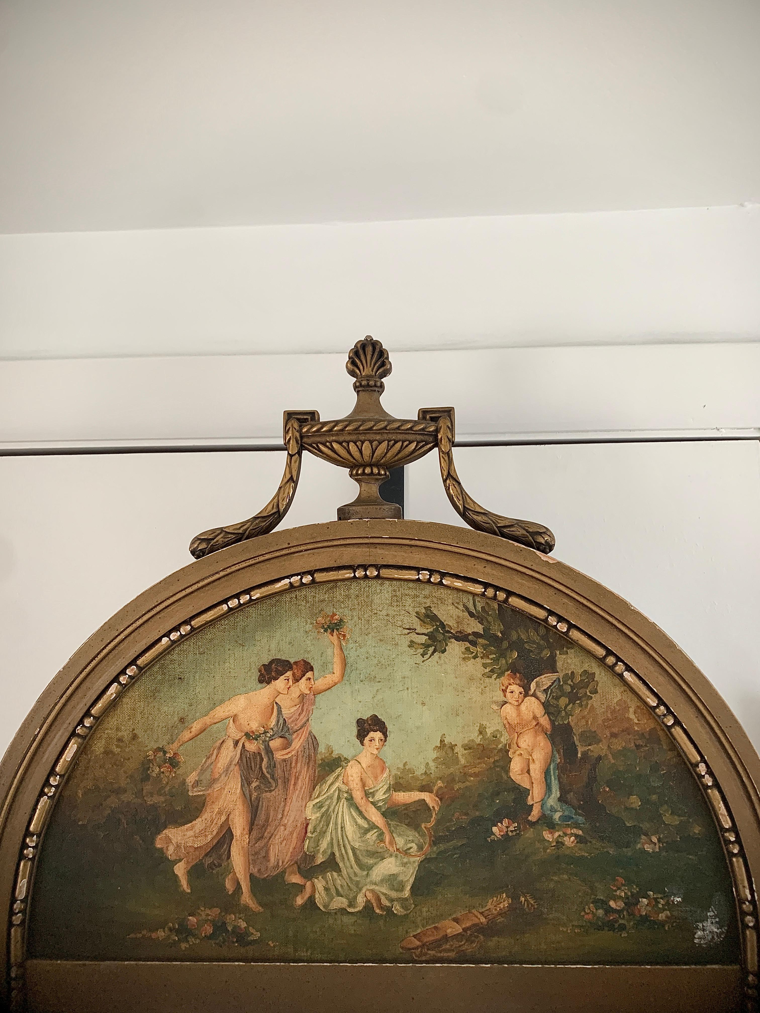 A gorgeous neoclassical French Provincial style Trumeau mirror.

Circa 1920s

Giltwood frame, with painted scene of ladies & putti, and original mirror glass.

Measures: 21