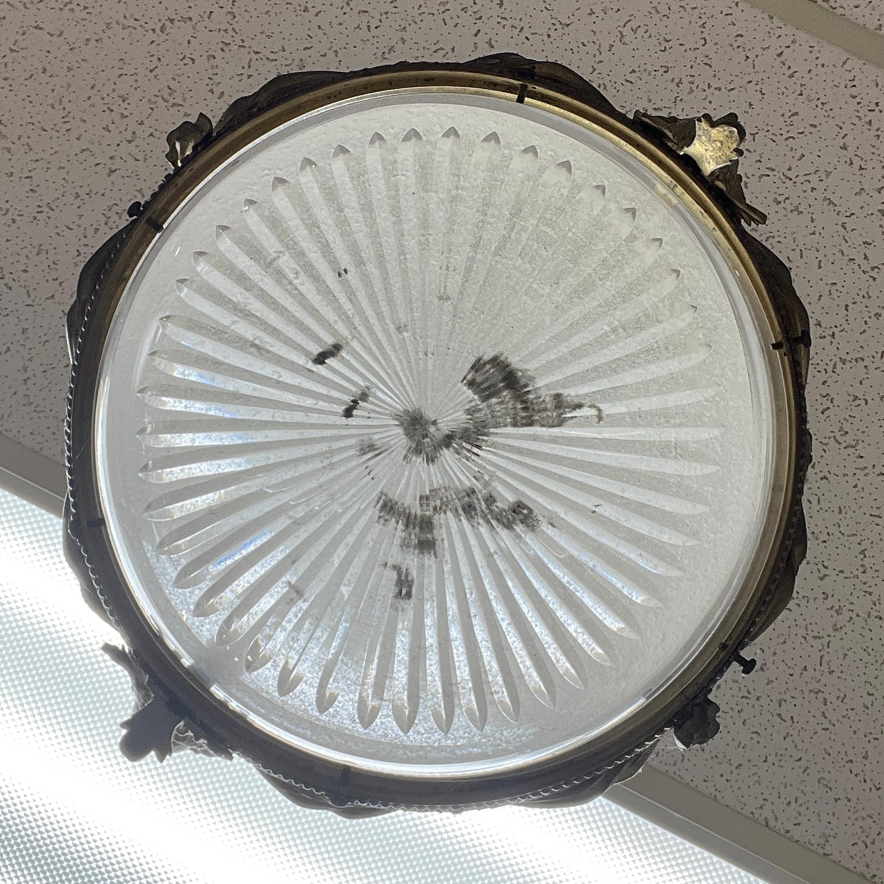 Eccezionale lampadario circolare in bronzo dorato del XIX secolo in stile neoclassico, con struttura circolare decorata con nastri intrecciati, rosette, drappeggi e perline, con maschere di Arlecchino a sinistra e a destra, con piastra originale e