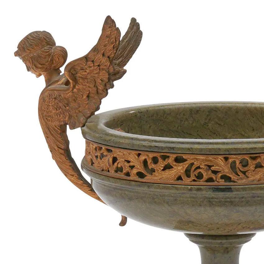 Our antique (late 19th century) footed centerpiece bowl is finely carved from green marble with gilt bronze mounts including foliate band below the rim, beading at the base of the socle, and two prominent angelic figures.  Apparently unsigned.