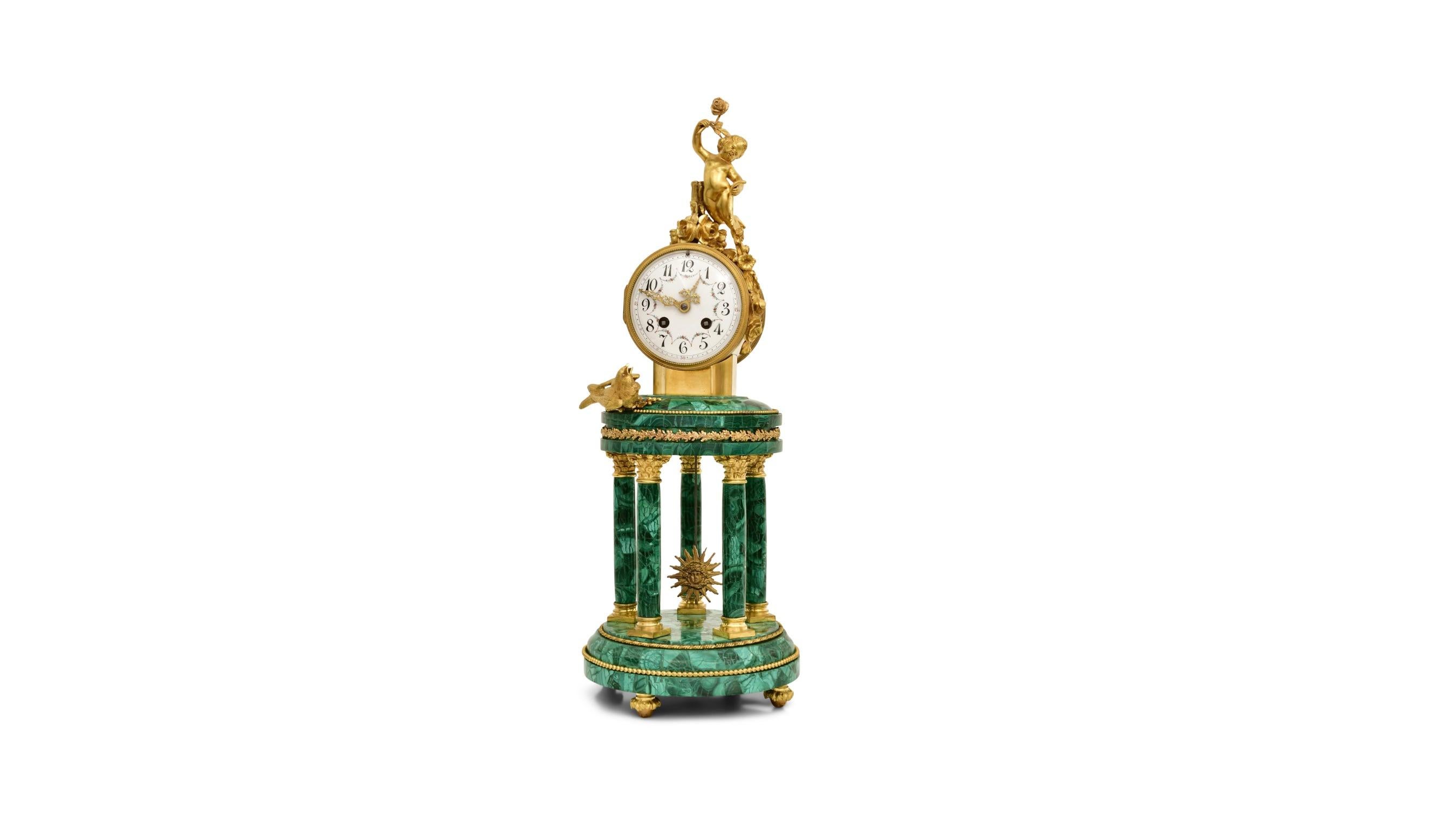 A striking example of mid-19th century French craftsmanship, this Louis XVI-style mantel clock is a perfect blend of classical elegance and refined detail. The architectural case is designed in the form of a temple, featuring five fluted Corinthian