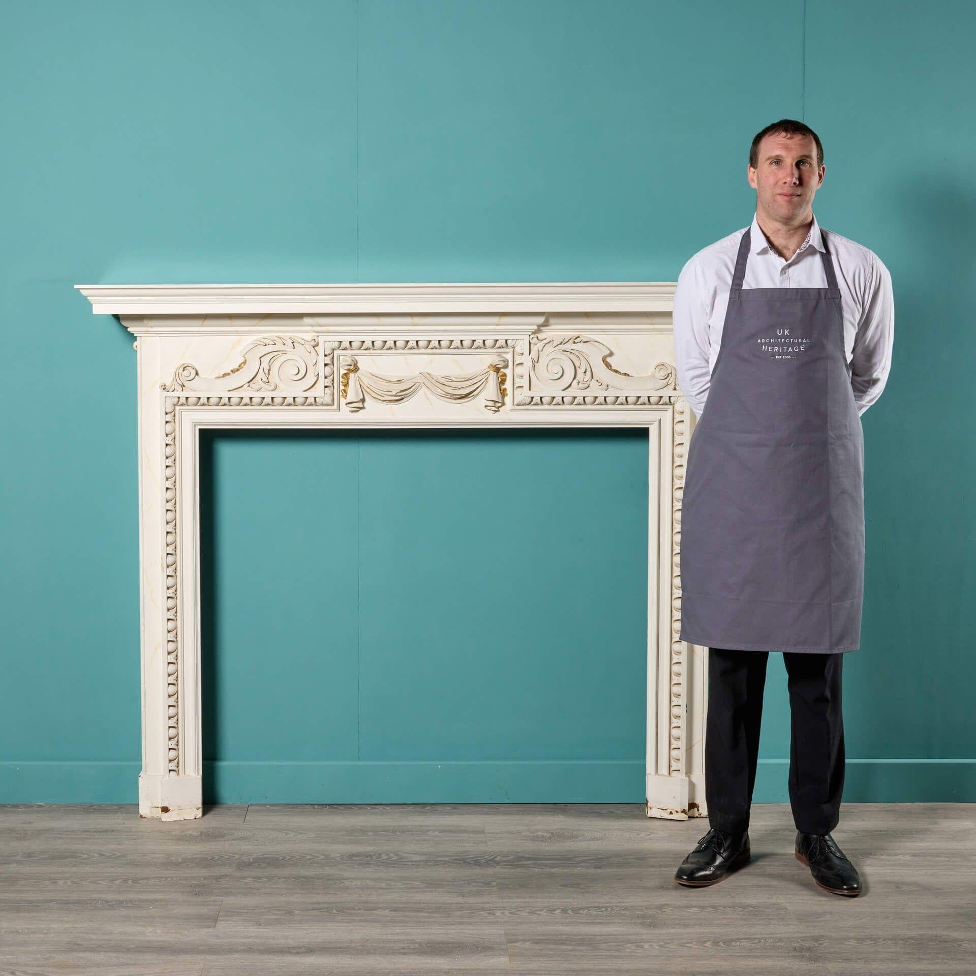 An antique neoclassical painted oak firemantel , sourced from a £13 million house in Hampstead, London.

Painted with a faux marble effect and highlighted with traces of gilding, this late 19th century fire surround is an impressive chimneypiece,