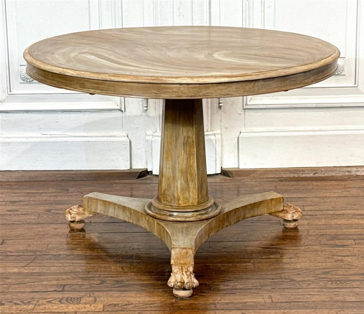 A striking antique European Palladian Neoclassical style later stripped bleached whitewashed mahogany pedestal center table.

19th century, having a round top with highly figured mahogany grain patterns, rising on a tapered faceted support,