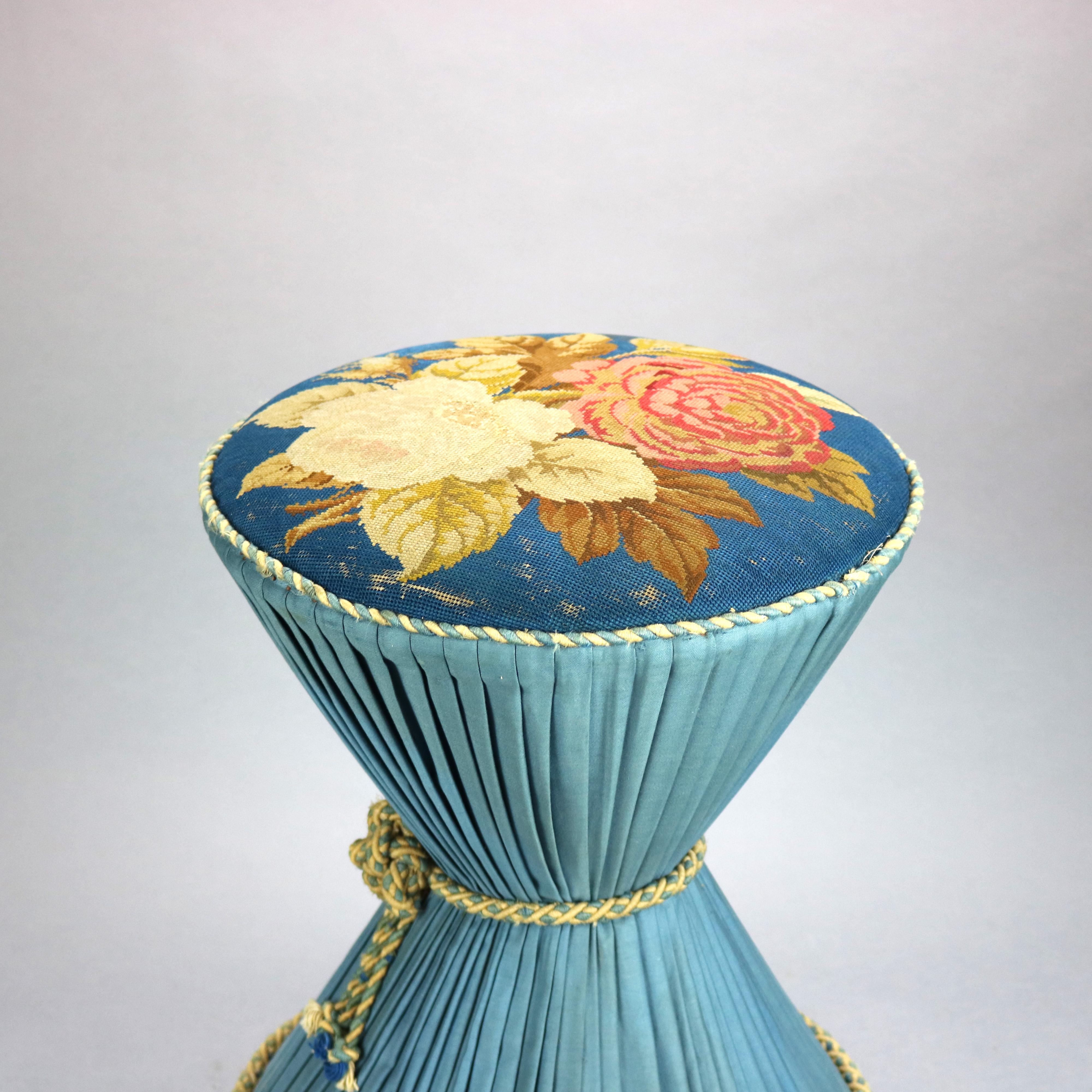 An antique neoclassical vanity stool or ottoman offers hourglass form with floral needlepoint upholstered seat over pleated and tied base raised on rosewood plinth with bun feet, c1870

Measures: 19.5