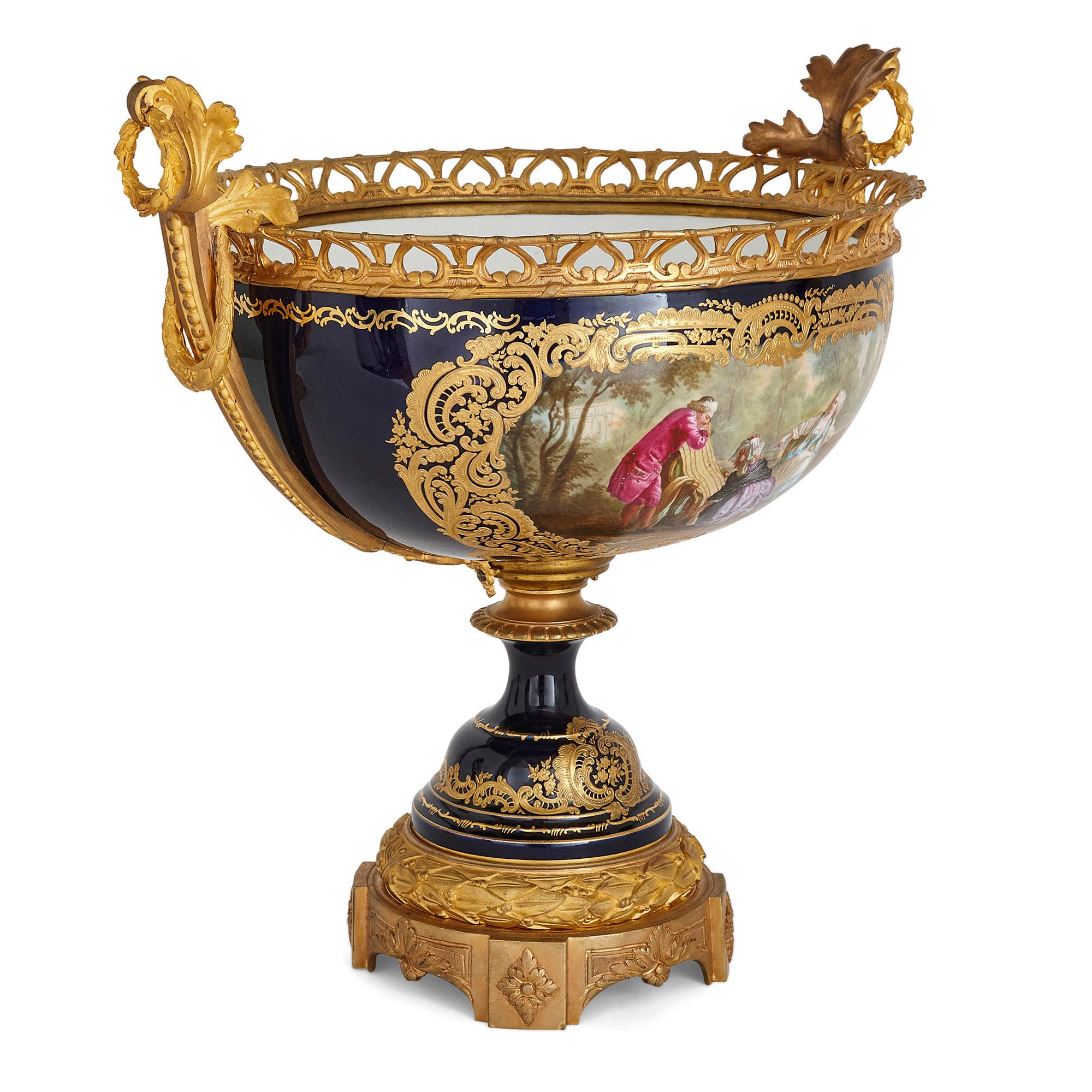 Antique neoclassical Sèvres style porcelain and gilt bronze jardinière and vases
French, 19th century
Measures: Jardinière height 47cm, width 49cm, depth 39cm
Vases height 56cm, width 26cm, depth 19cm

Consisting of a central jardinière and