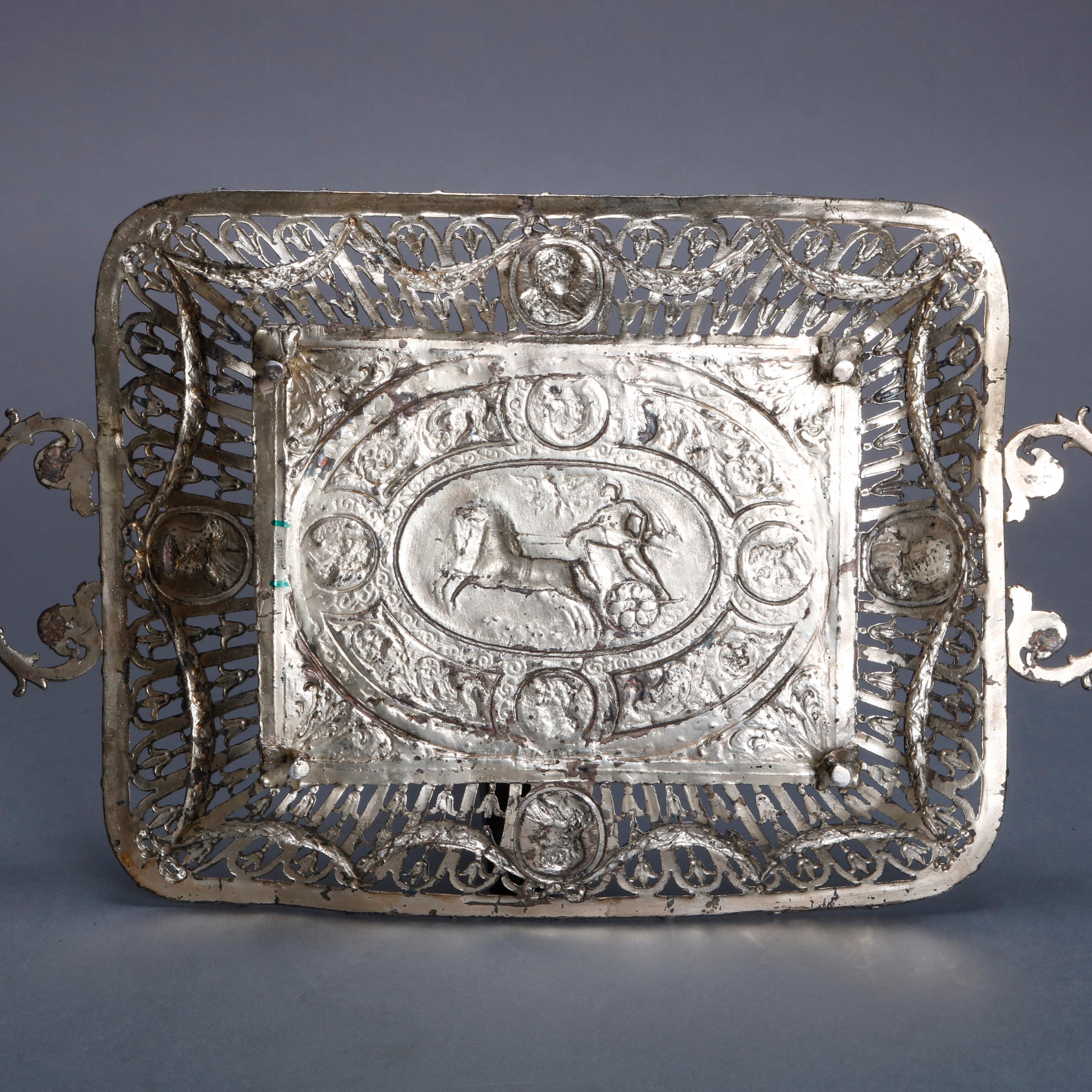 An antique neoclassical double handled tray offers sterling silver construction with central high relief medallion depicting Roman Warrior on his horse draw chariot in countryside setting, pierced sides with stylized floral elements, cameos and