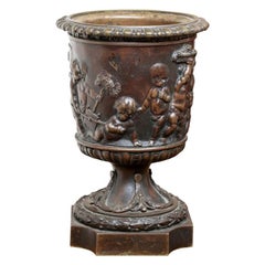 Antique Neoclassical Style Bronze Urn with Putti in Relief