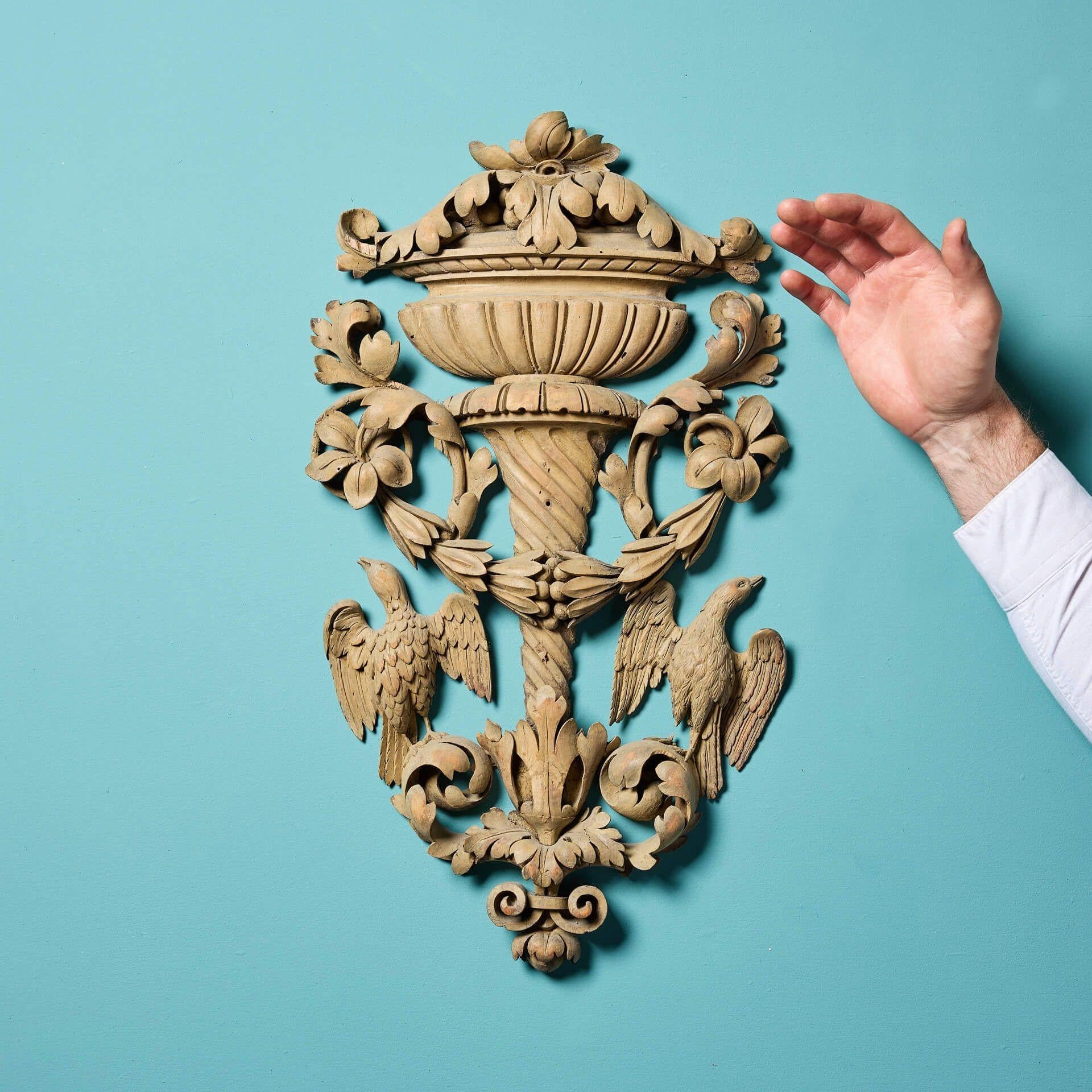 An antique neoclassical style carved lime wood wall panel.

This striking piece would make a charming wall decoration on the main wall of a period property.

Dating to 1780, this handcarved antique displays an elegant Neoclassical style fountain