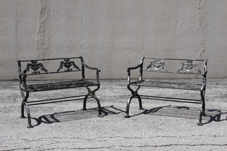 Antique cast aluminum Regency or Neoclassical style garden set consisting of two benches or settees. The set is inspired by a design circa 1835 by artist Karl Friedrich Schinkel (1781-1841) and is on the smaller scale in size. The benches have rod