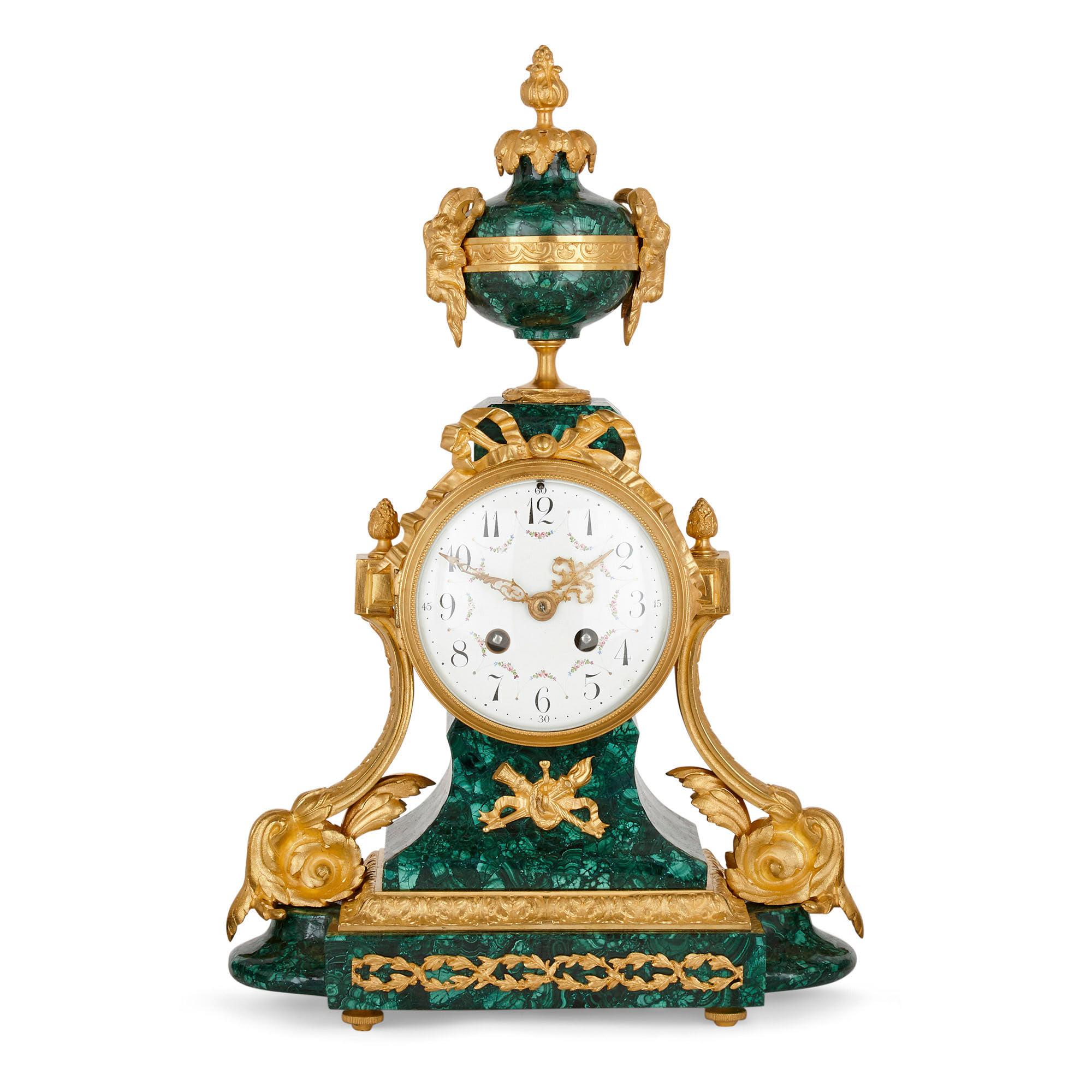 Antique Neoclassical style French mantel clock with twin vases,
French, early 20th century
Clock: Height 42cm, width 11cm, depth 14cm
Vases: Height 33cm, diameter 9.5cm

Designed in the distinctive Louis XVI Neoclassical Style, this early 20th