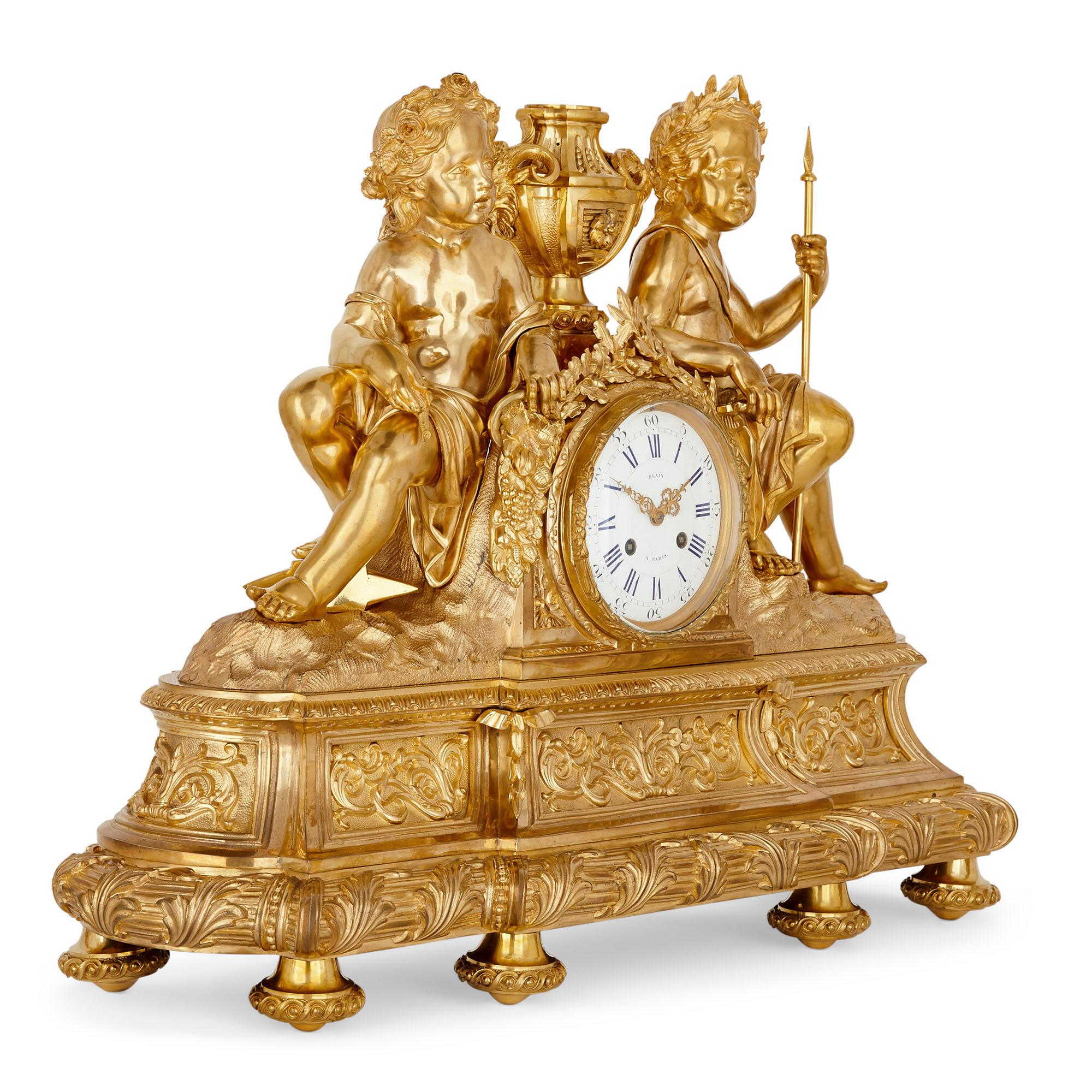 Antique neoclassical style three-piece gilt bronze clock set
French, late 19th century
Measures: Clock: Height 57cm, width 74cm, depth 23cm.
Candelabra: Height 83cm, width 27cm, depth 17cm

This fine clock set is comprised of a central mantel