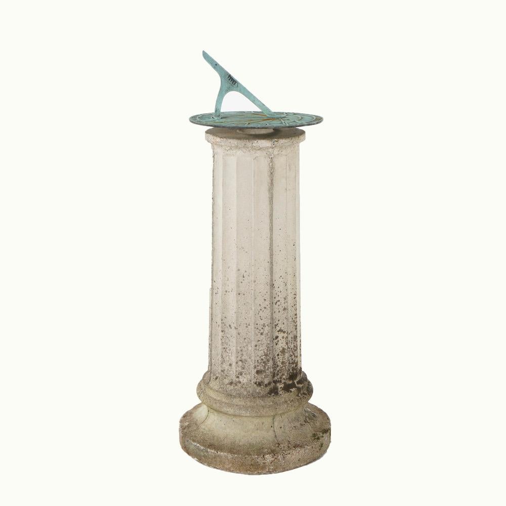 An antique Neoclassical garden sundial offers verdigris dial having Roman numerals and raised on cast stone Doric column base, c1920

Measures- 30''H x 11.75''W x 11.75''D.

Catalogue Note: Ask about DISCOUNTED DELIVERY RATES available to most