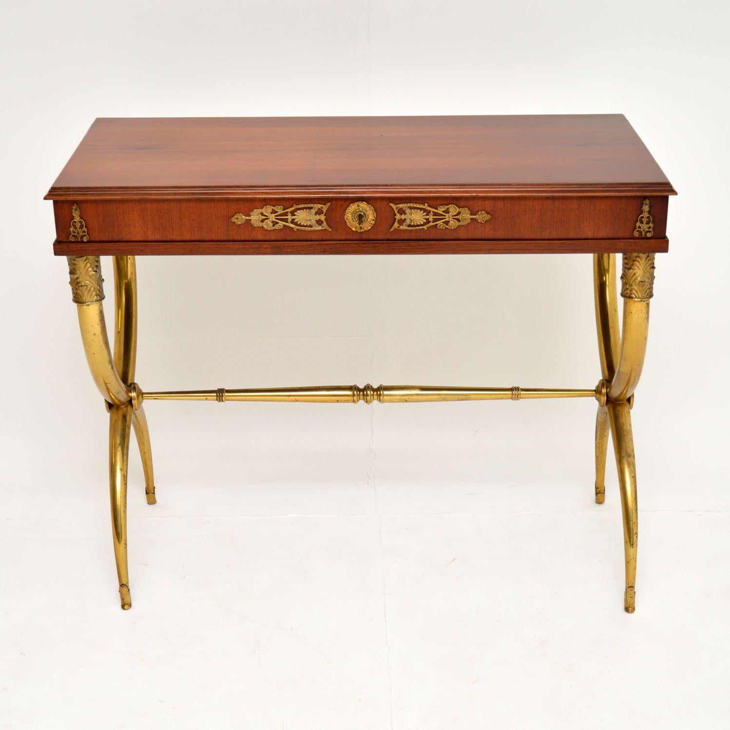 A stunning and very stylish antique neoclassical table, beautifully made from walnut and brass. This is in the antique Regency style and I would date it from circa 1920s-1930s. It is a great size to be used as a desk, dressing table or console side