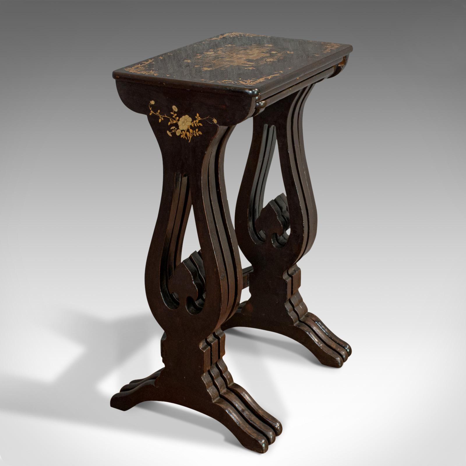 This is an antique nest of three occasional tables. An oriental, ebonized trio in typically Japanned taste, dating to the Victorian period, circa 1880.

Ebonized with gilt inlay and a Japanned finish, each table is beautifully decorated with a