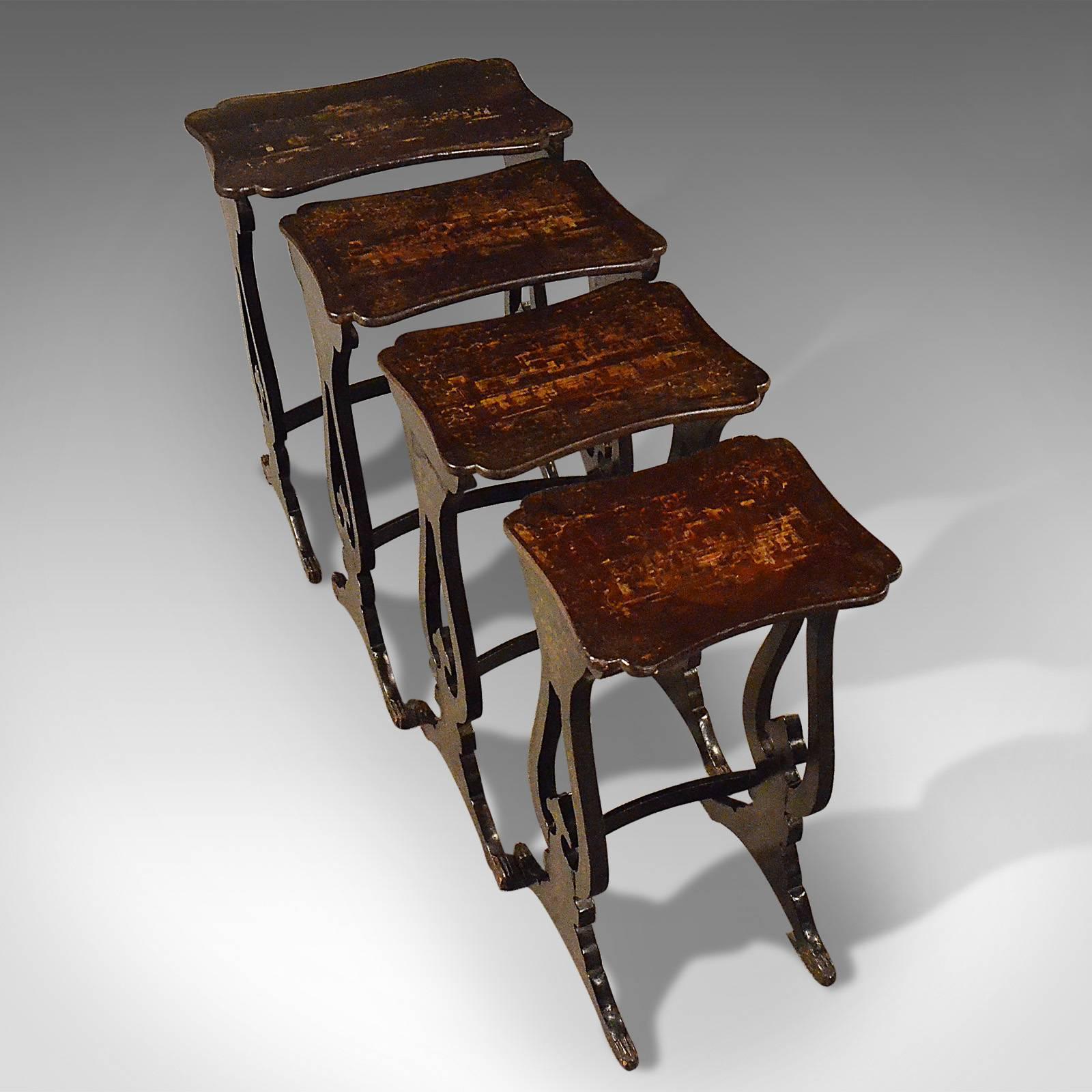 This is an antique nest of tables, four Chinoiserie ebonized and Japanned side tables from the 19th century, circa 1890.

Of quality craftsmanship, strongly jointed and robust
Hand decorated with fine gilt paint detailing throughout 
Depicting