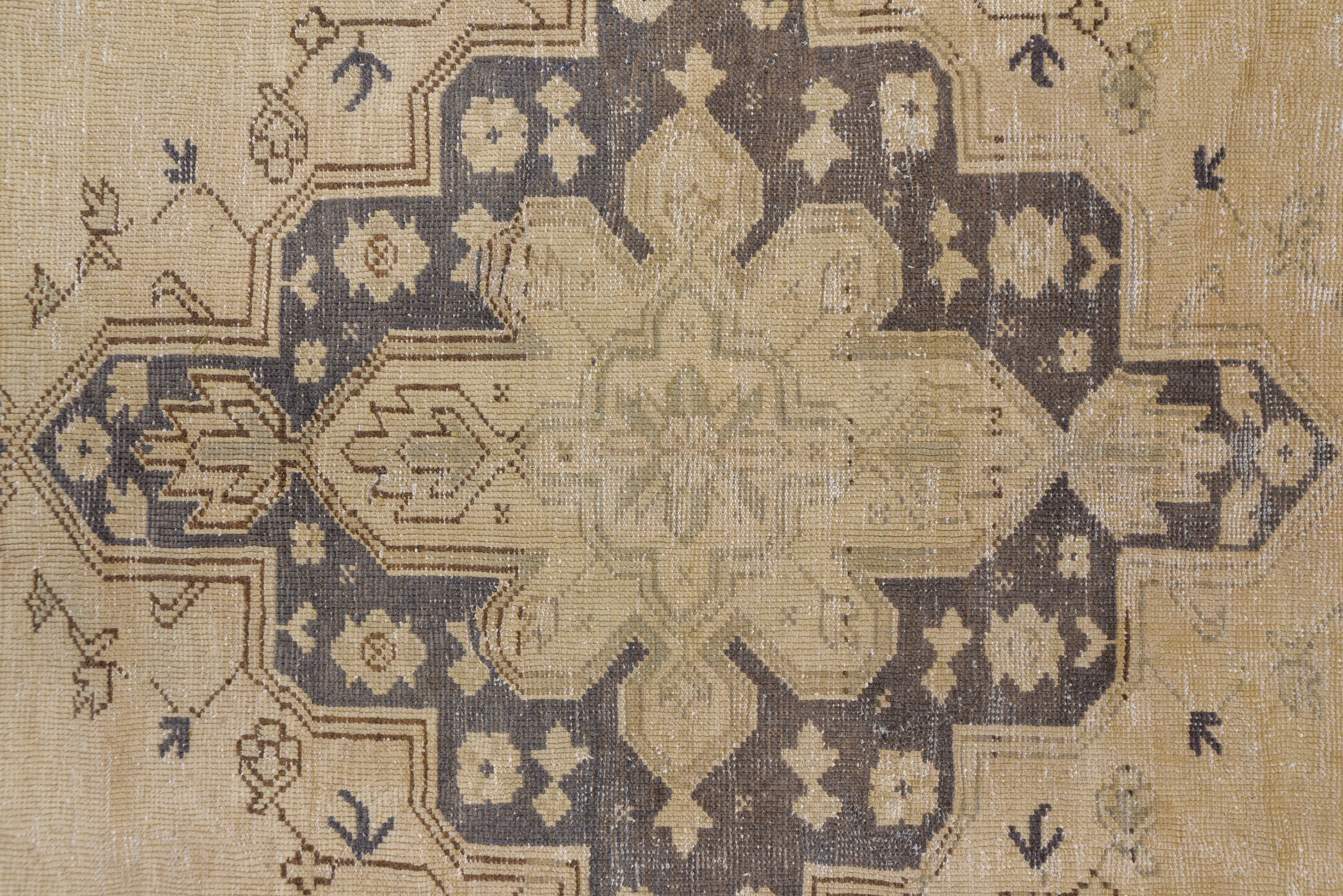 Somewhat in the popular Heriz style, this western Turkish town carpet shows a lobed and pendanted slate medallion on an open field of blush-peach, within an abrashed dark slate border of angular rosettes, palmettes and leaves. Satisfying composition.