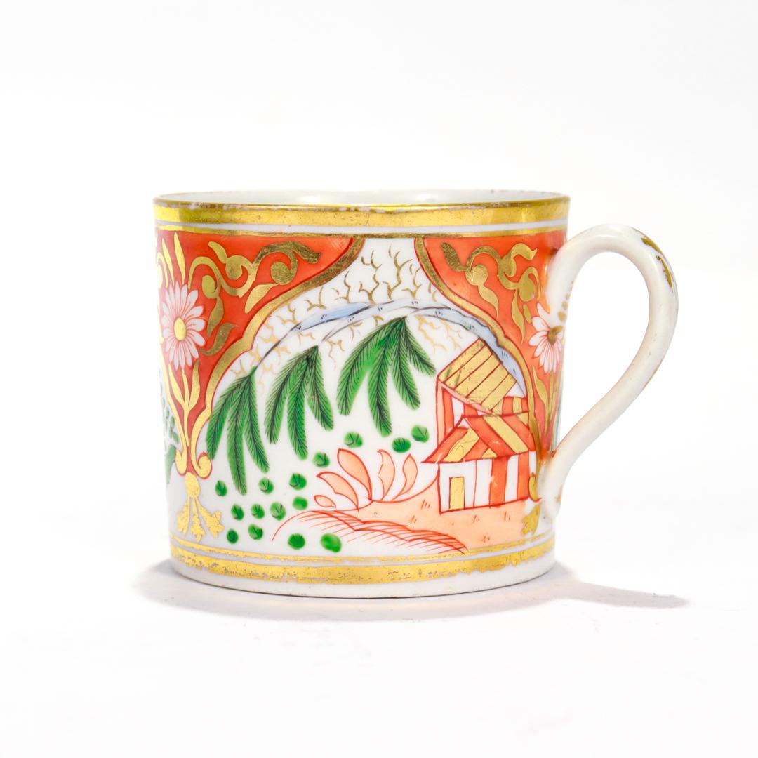 A fine antique English porcelain coffee cup (or cann).

By New Hall.

In a typical, cylindrical form with a ear shaped handle and an orange house & willow Imari pattern decoration.

In cold painted blue, and green, and oranges with elaborate gilding