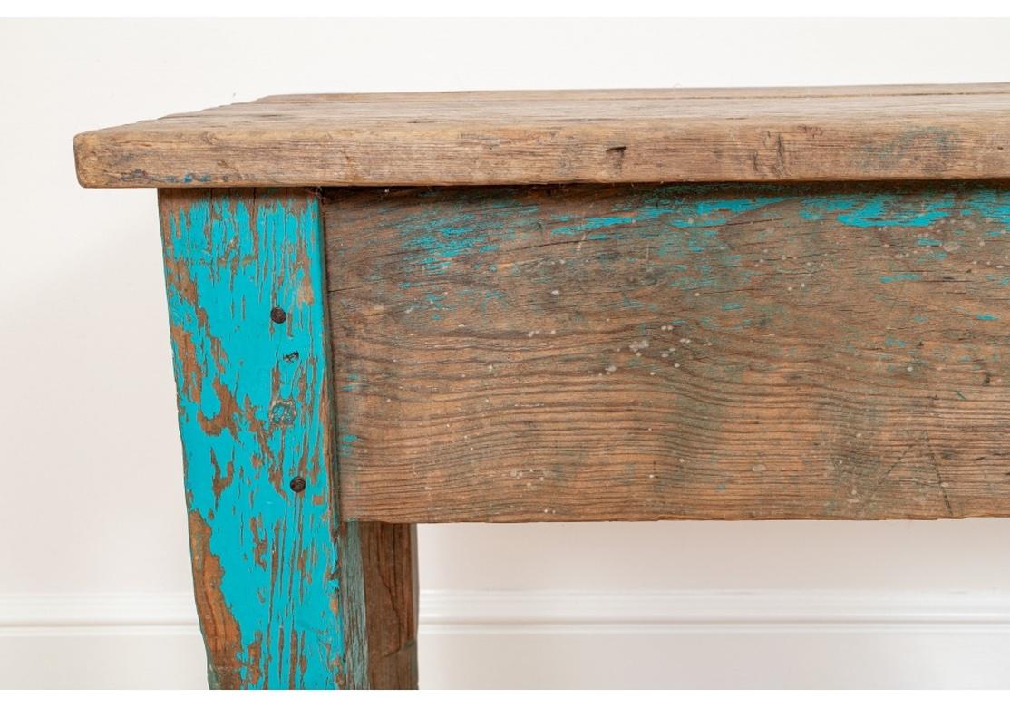 A very well made and decorative New Mexican Console Table having desirable all over weathering and time-worn appeal. A single drawer with a Primitive Mexican Iron pull completes the Colorful and Rustic Style. 
Table measures 50” wide by 15” deep by