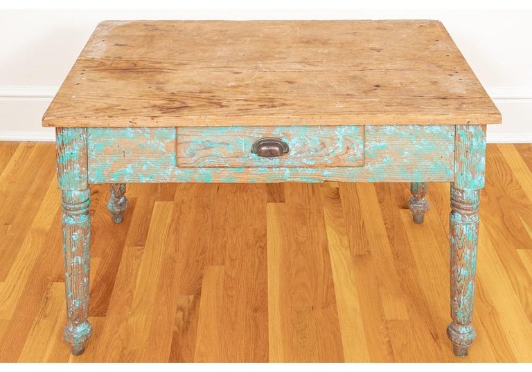 A very solidly made 19th century work table with Natural Top and Turquoise Paint decorated legs and apron from New Mexico. The Table has strongly turned legs, tool drawer with Bin-Pull handle and is in a useful size for a variety of uses. 
Table
