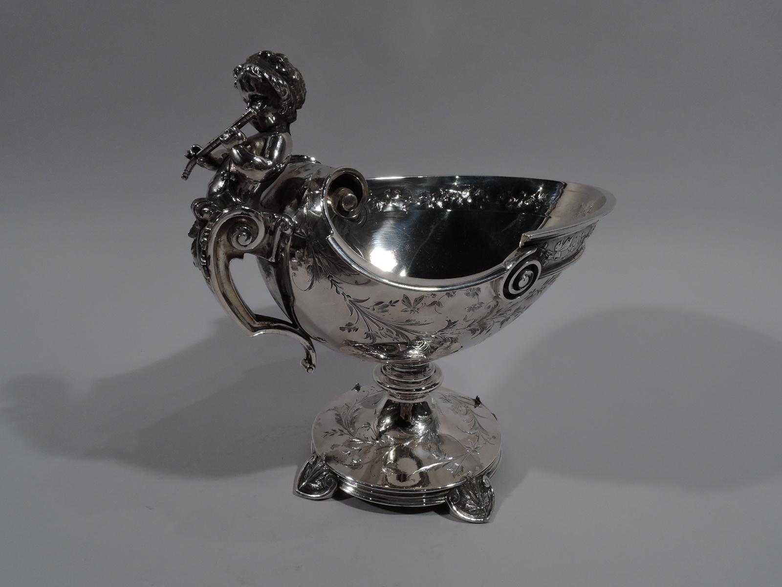 American Greek Revival sterling silver compote, circa 1865. Oval helmet bowl on short knopped stem flowing into round foot support by 4 leaf-capped scrolled shield supports. Leaf-capped scroll bracket handle with cast herm in figure of piping