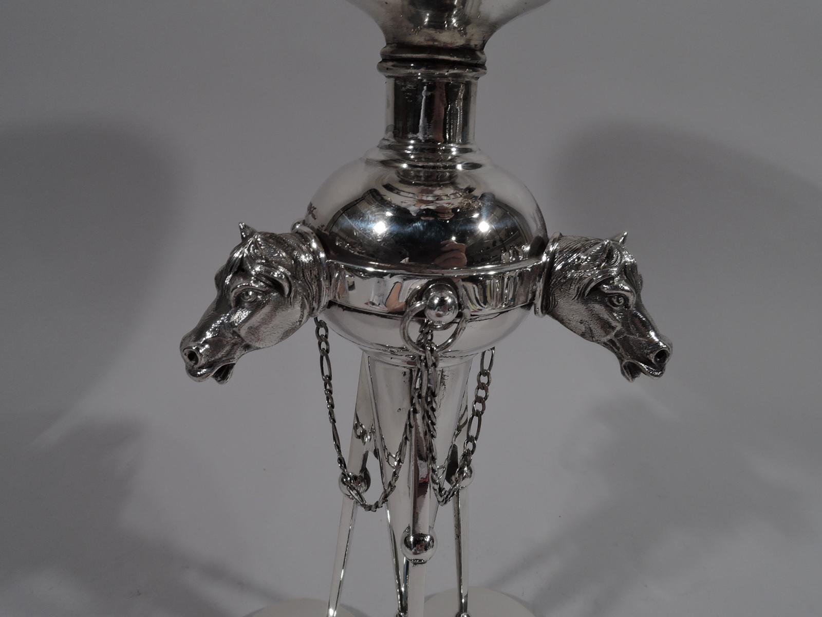 Tall and stylish avant-garde sterling silver horse compote, circa 1870. Round bowl with beaded rim on short support mounted to globe with pendant cone. Tripod support with stylized hoof-and-scroll feet mounted to trefoil foot with stylized