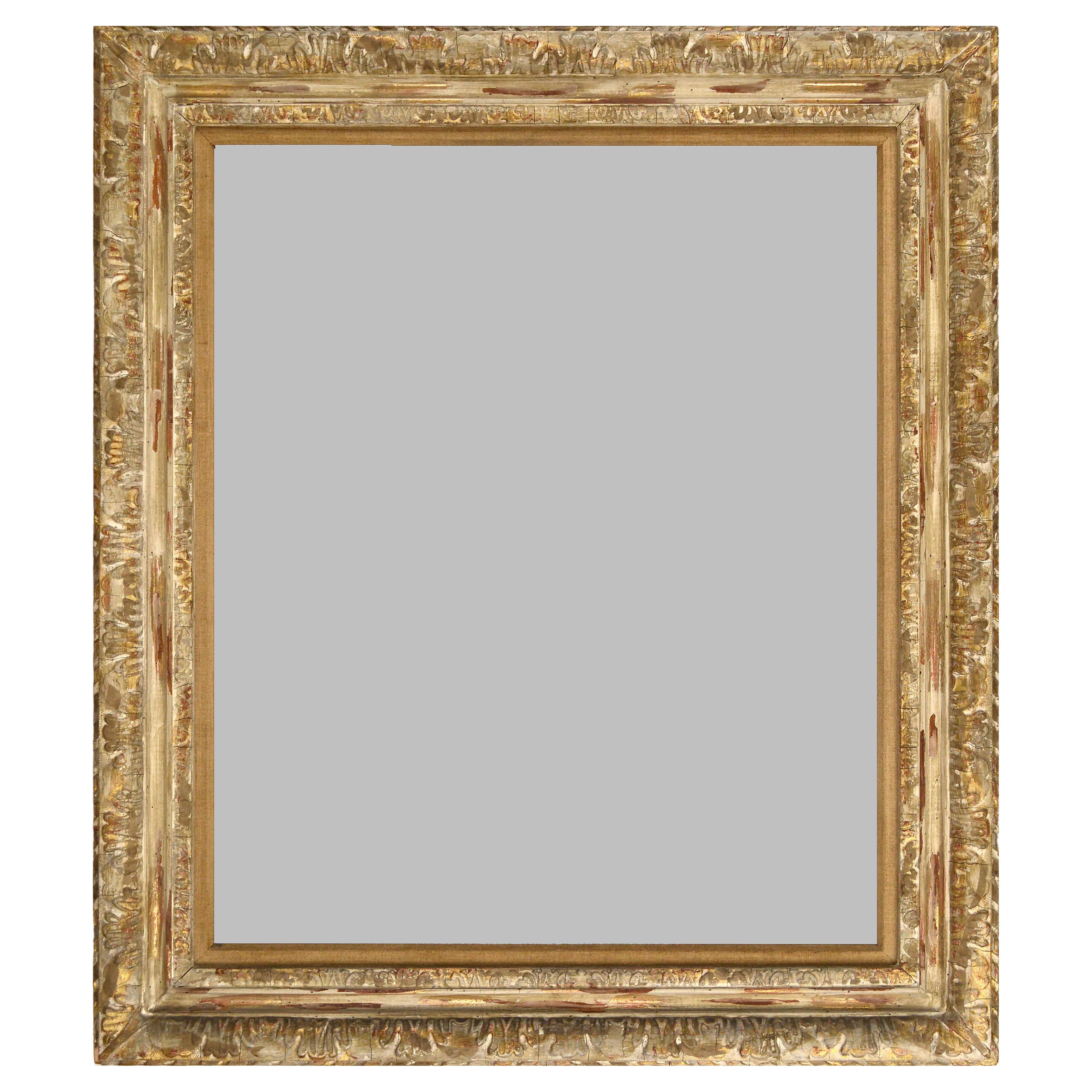 Fine and elegant antique Newcomb-Macklin carved giltwood frame. This period Arts & Crafts frame, from the renowned New York framing company extolled for its exceptional design and craftsmanship, is carved with a beautiful and refined decorative