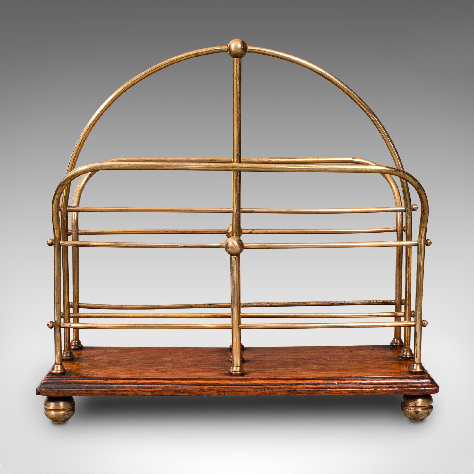 This is an antique newspaper rack. An English, oak and brass magazine or letter stand by Samuel Heath, dating to the late Victorian period, circa 1900.

Appealing Victorian stand, ideal for the morning paper or periodical
Displaying a desirable