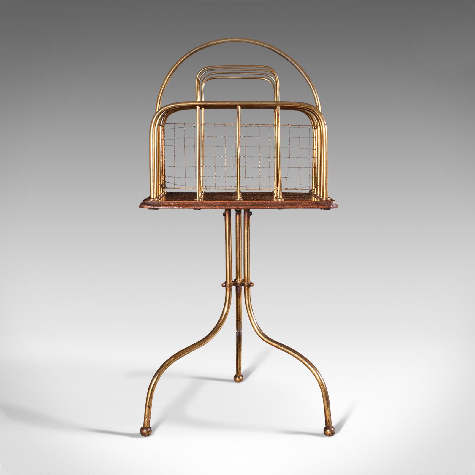This is an antique newspaper rack. A French, oak and brassed alloy magazine or music stand, dating to the late Victorian period, circa 1900.

Striking rack with great hues and sinuous forms
Displaying a desirable aged patina and in good