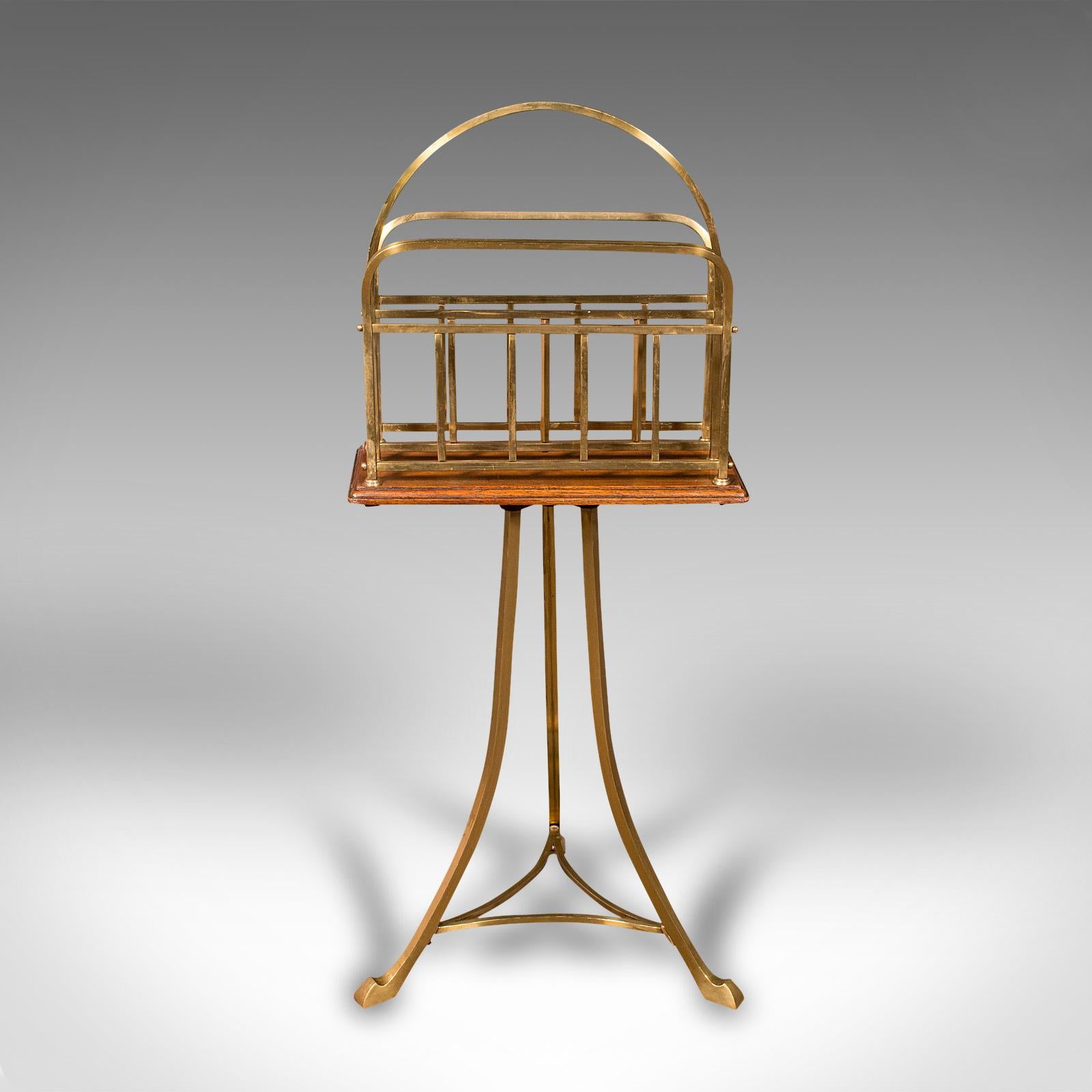 This is an antique newspaper stand. An English, oak and brass magazine or music rack, dating to the late Victorian period, circa 1900.

Elegant antique newspaper stand, ideal for the lounge or study
Displays a desirable aged patina and in good